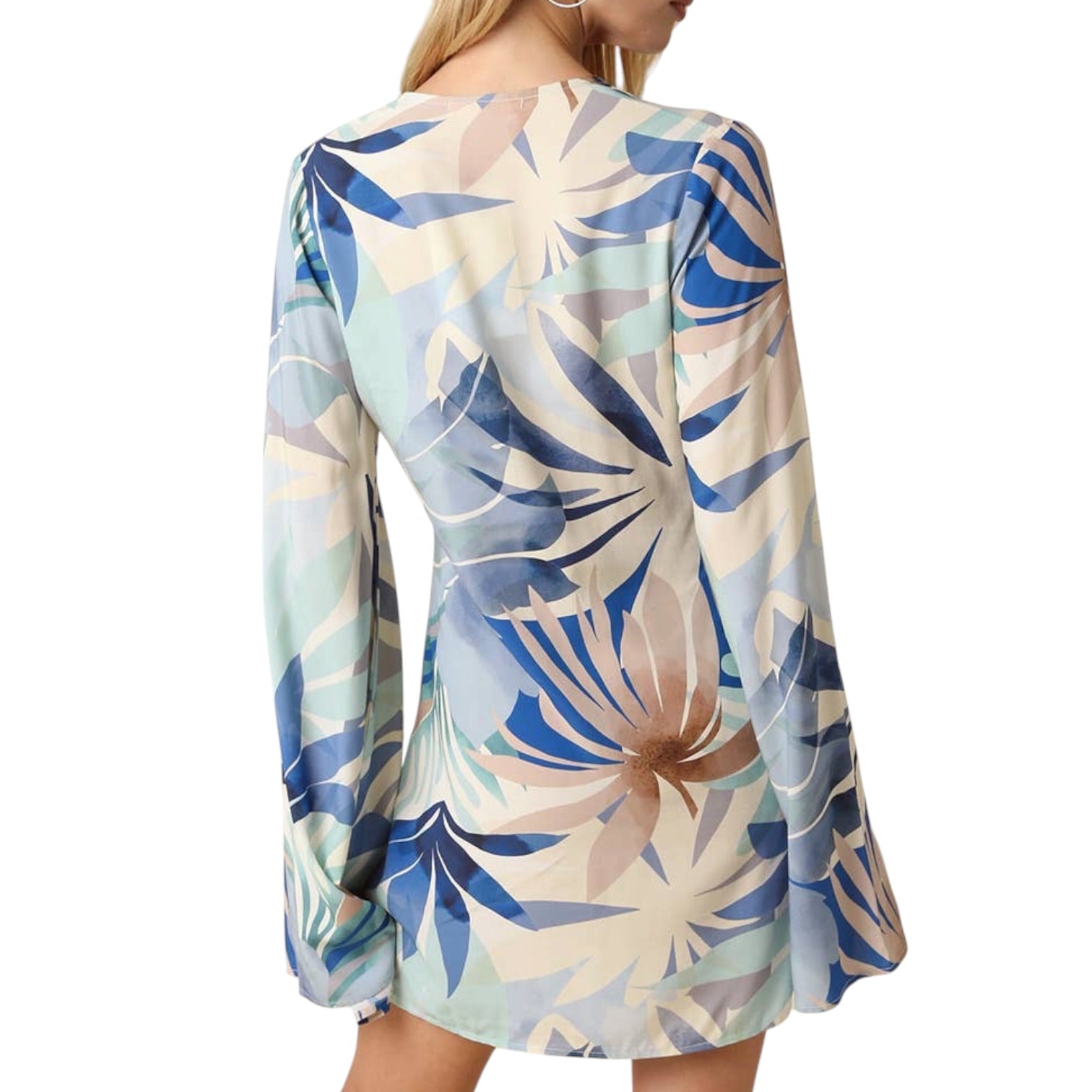 Woman wearing a floral patterned dress with long sleeves on a white background
