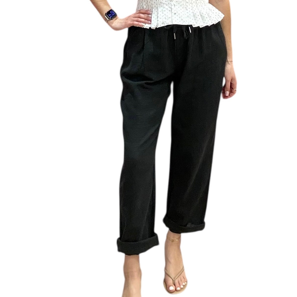 Black pants worn by a person on a white background