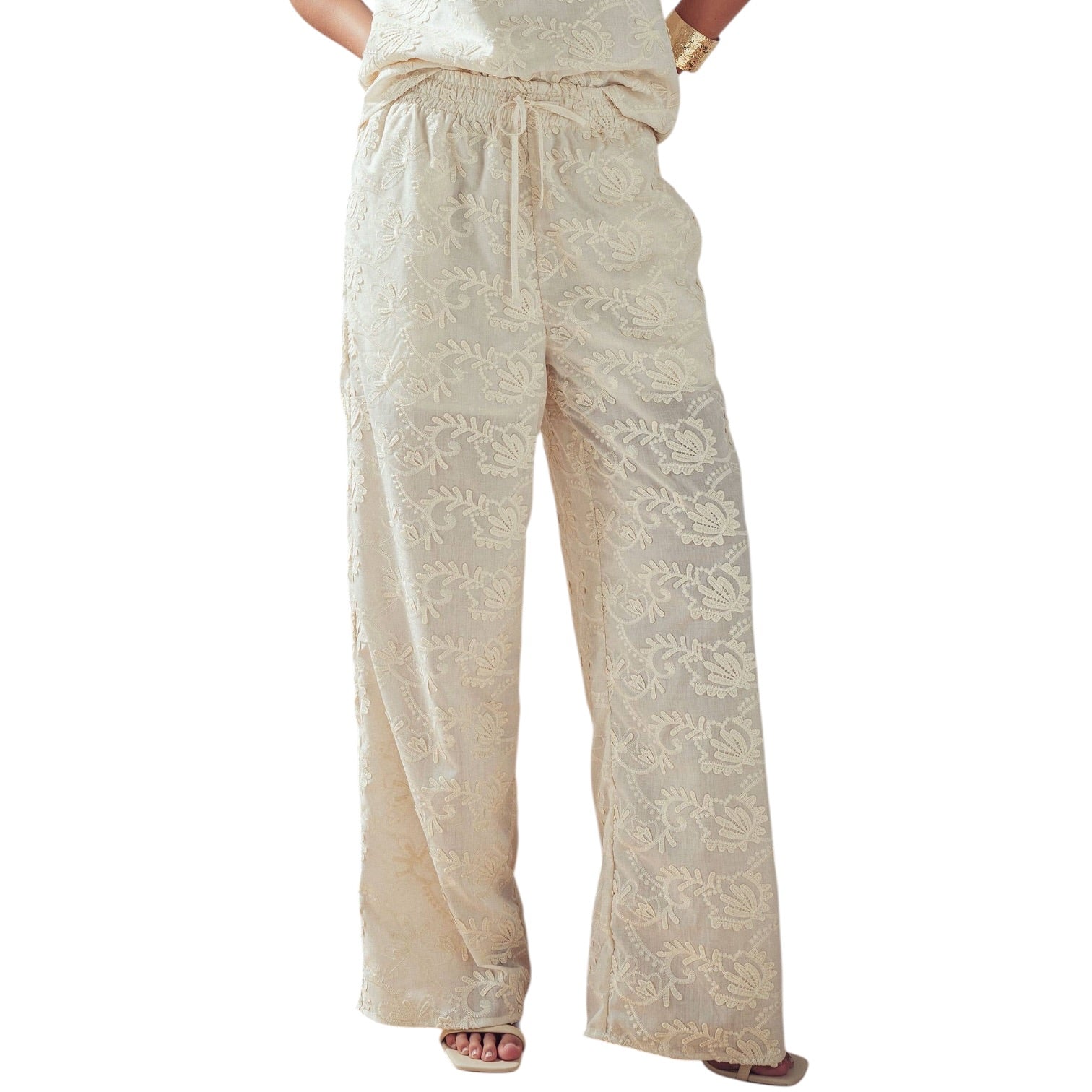 Beige embroidered pants on a white background