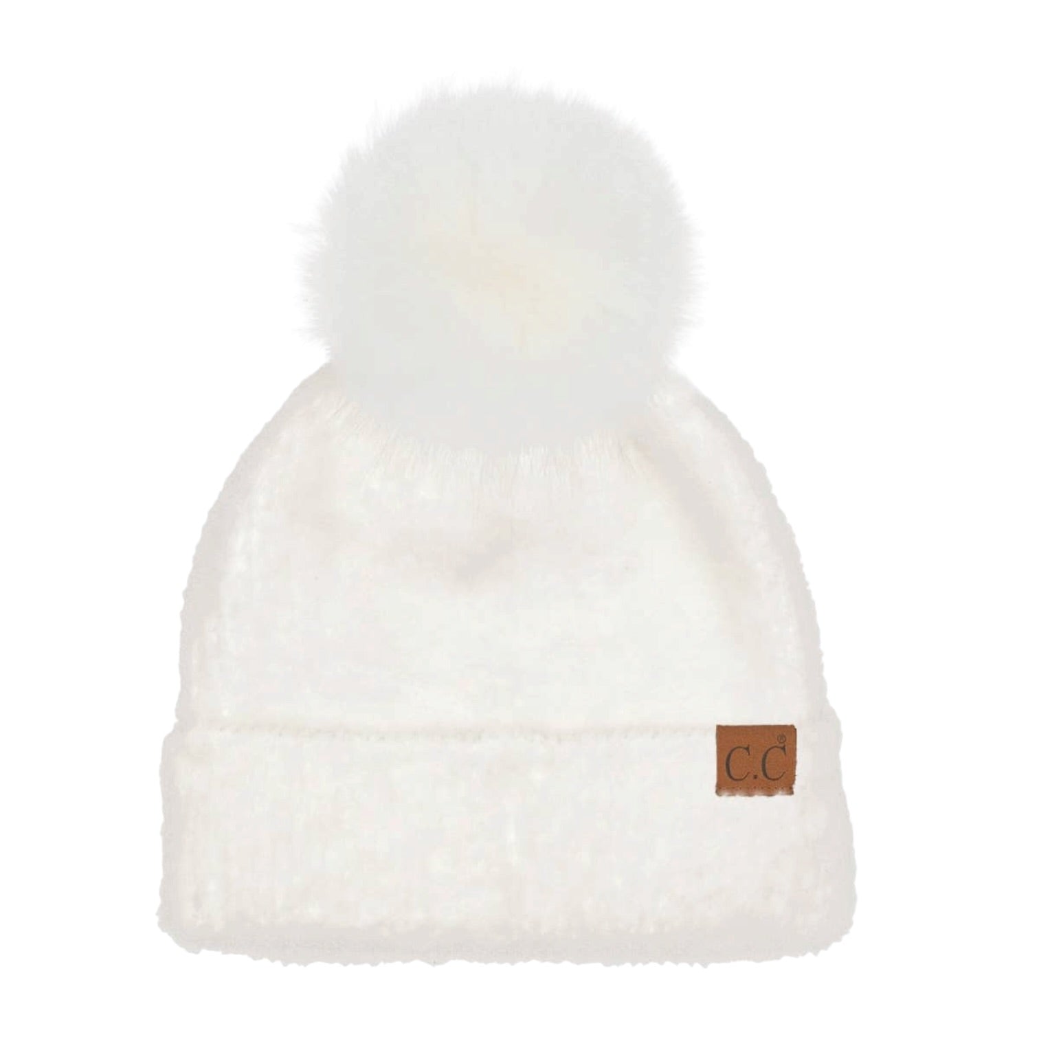 A fluffy white knit beanie with a large white faux-fur pom-pom on top and a small brown leather patch on the cuff featuring the letters 'CC'.