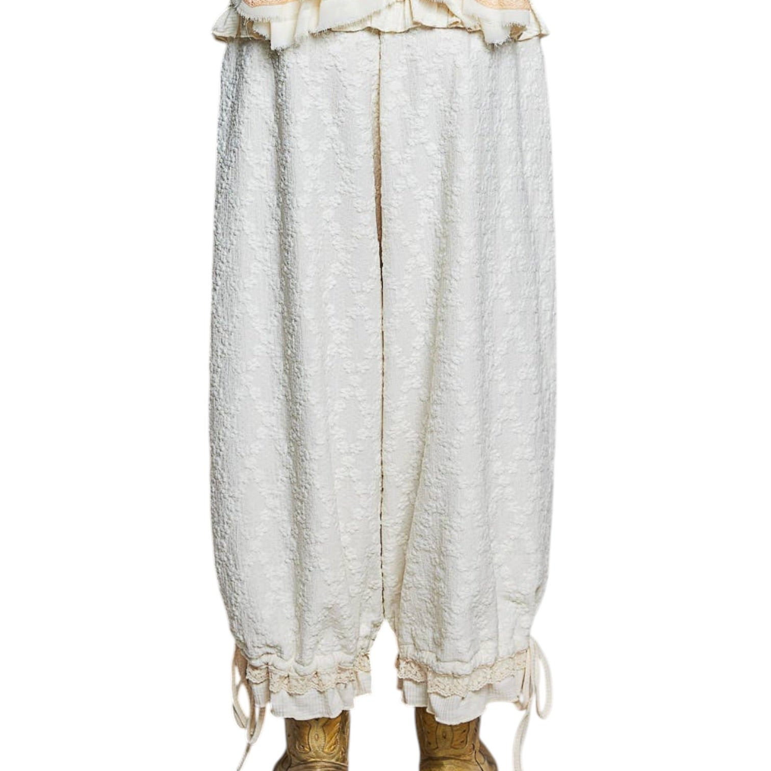 White lace pants with gold accents on a white background