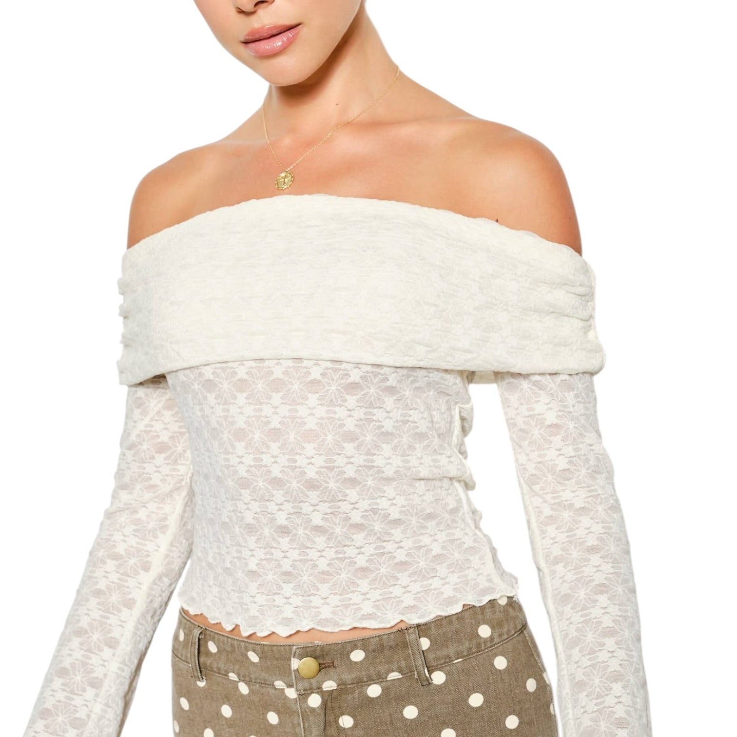 Woman wearing a white off-shoulder top with a plain background