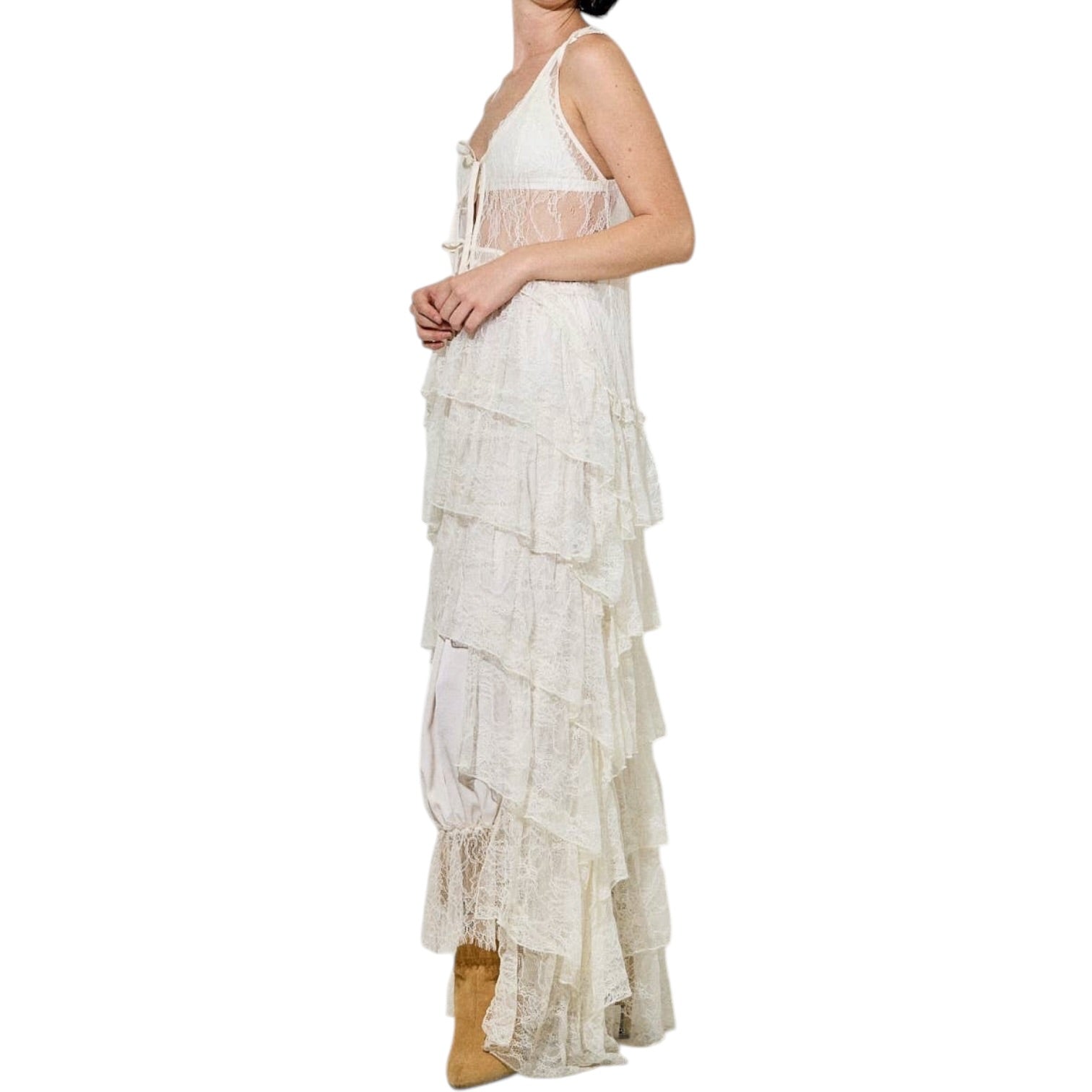Cream lace dress with tiered layers on a white background