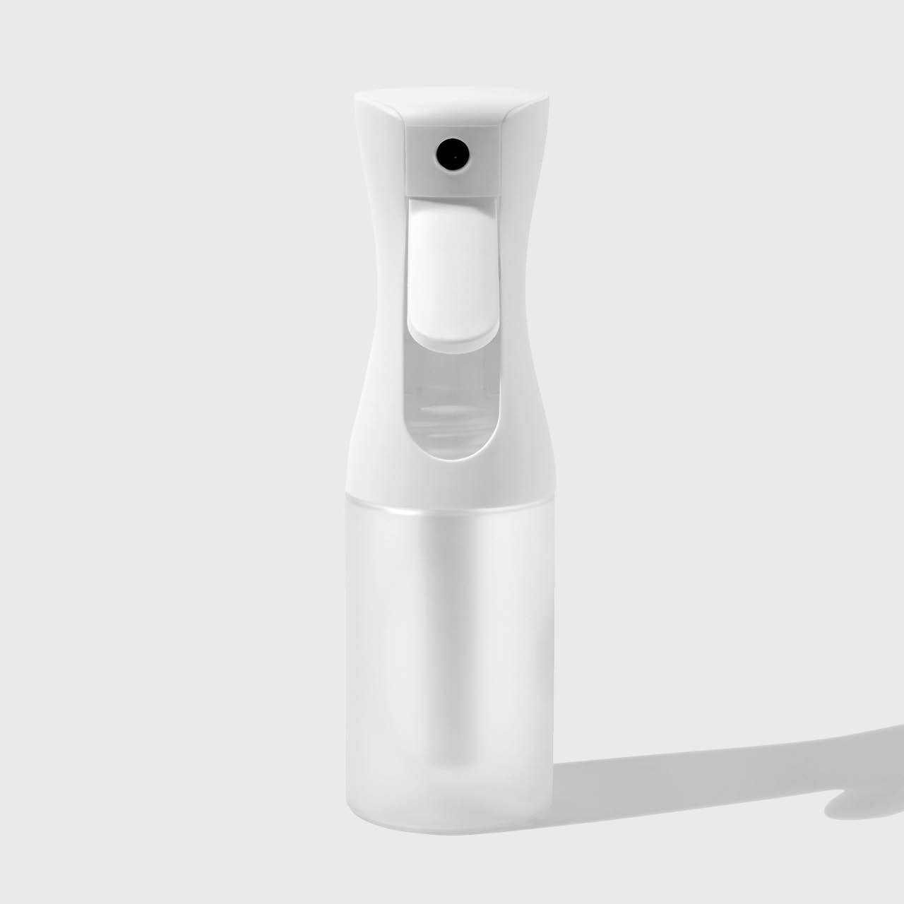 White spray bottle on a light gray background