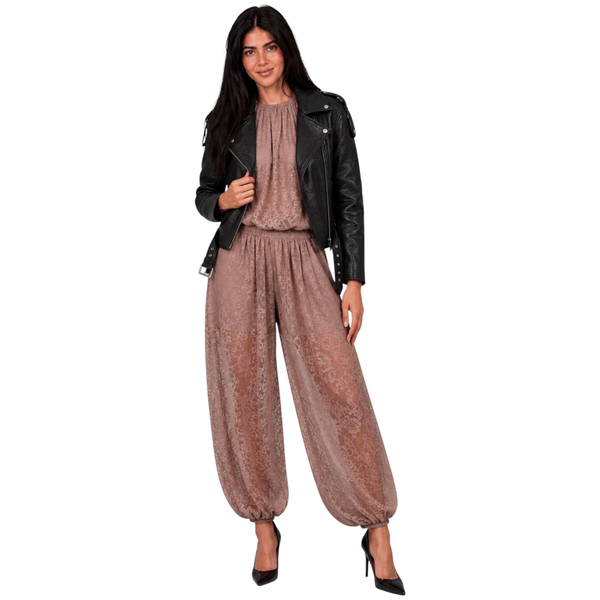 A woman modeling a two-piece outfit consisting of a dusty rose patterned top and matching wide-leg harem pants, styled with a black leather jacket and black heels against a plain white background.