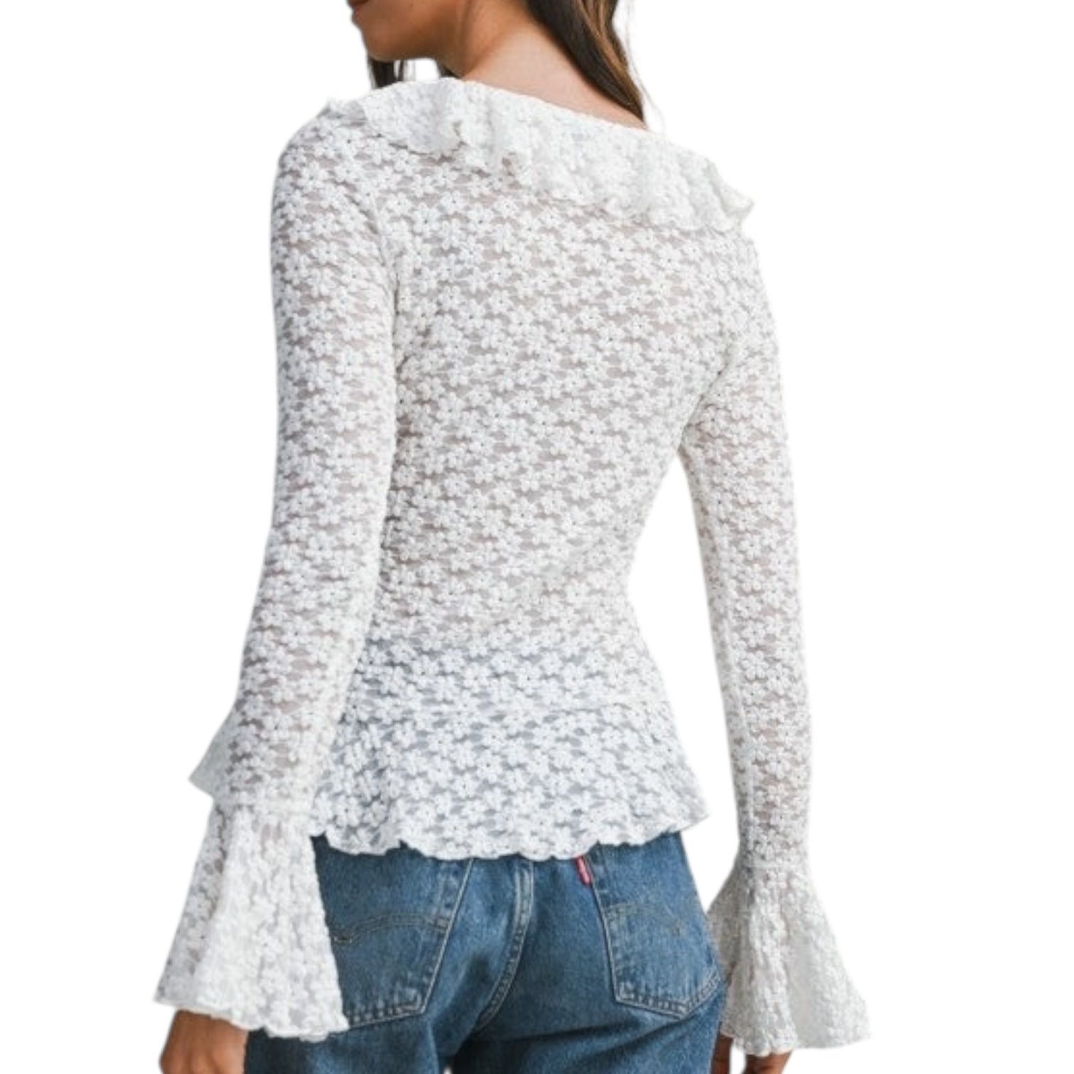 White floral blouse with ruffled sleeves worn by a person on a white background