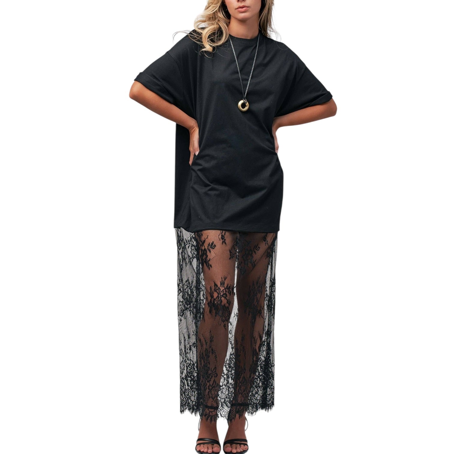 Black dress with sheer lace overlay worn by a mannequin on a white background