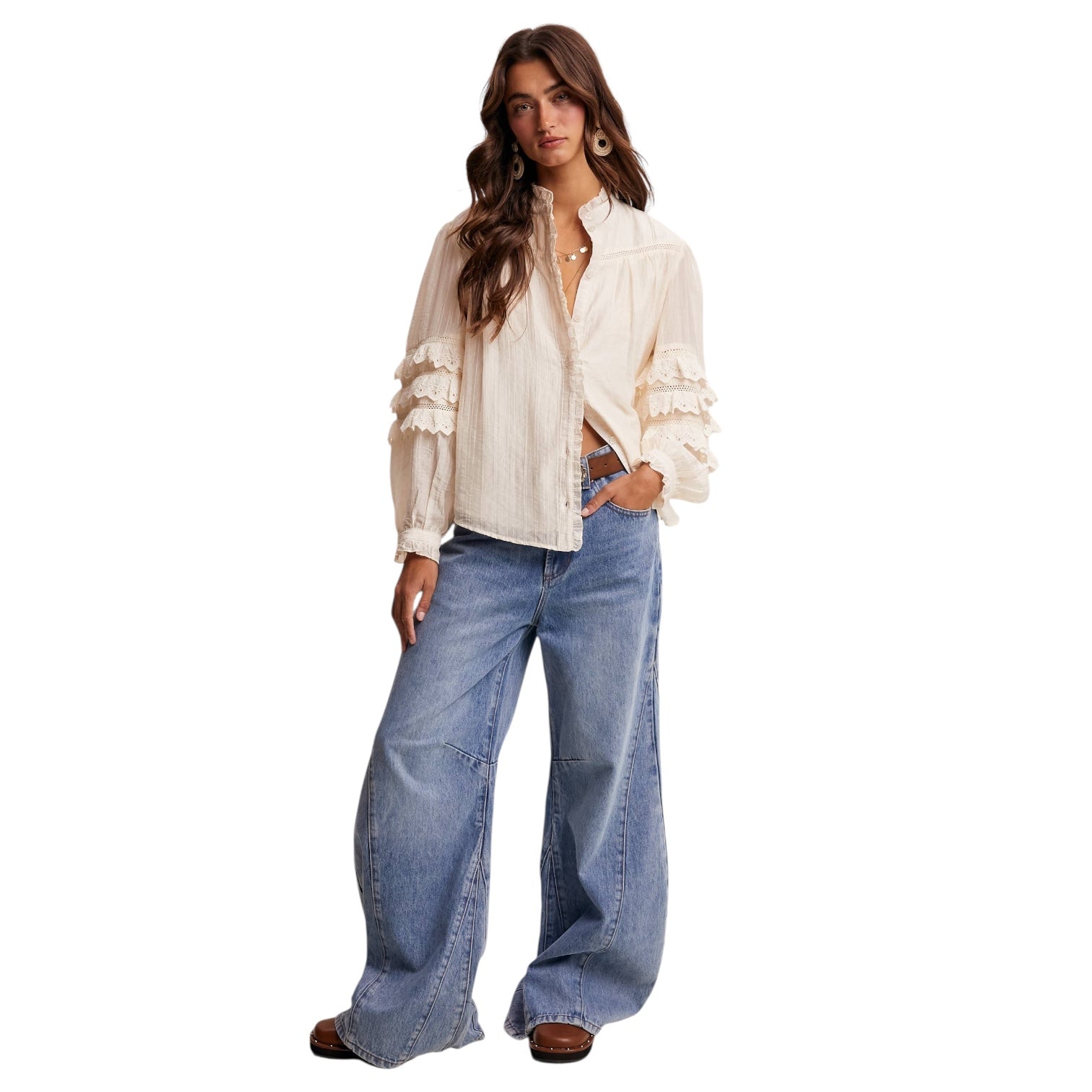 Woman wearing a white blouse and blue jeans on a white background