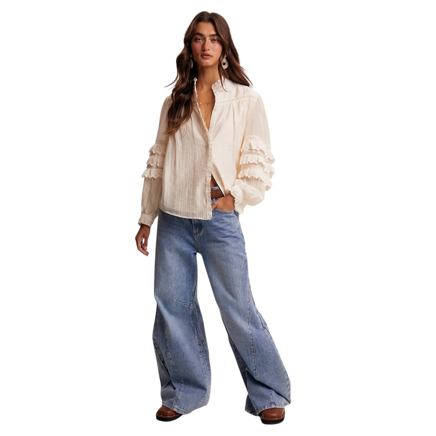 Woman wearing a white blouse and blue jeans on a white background