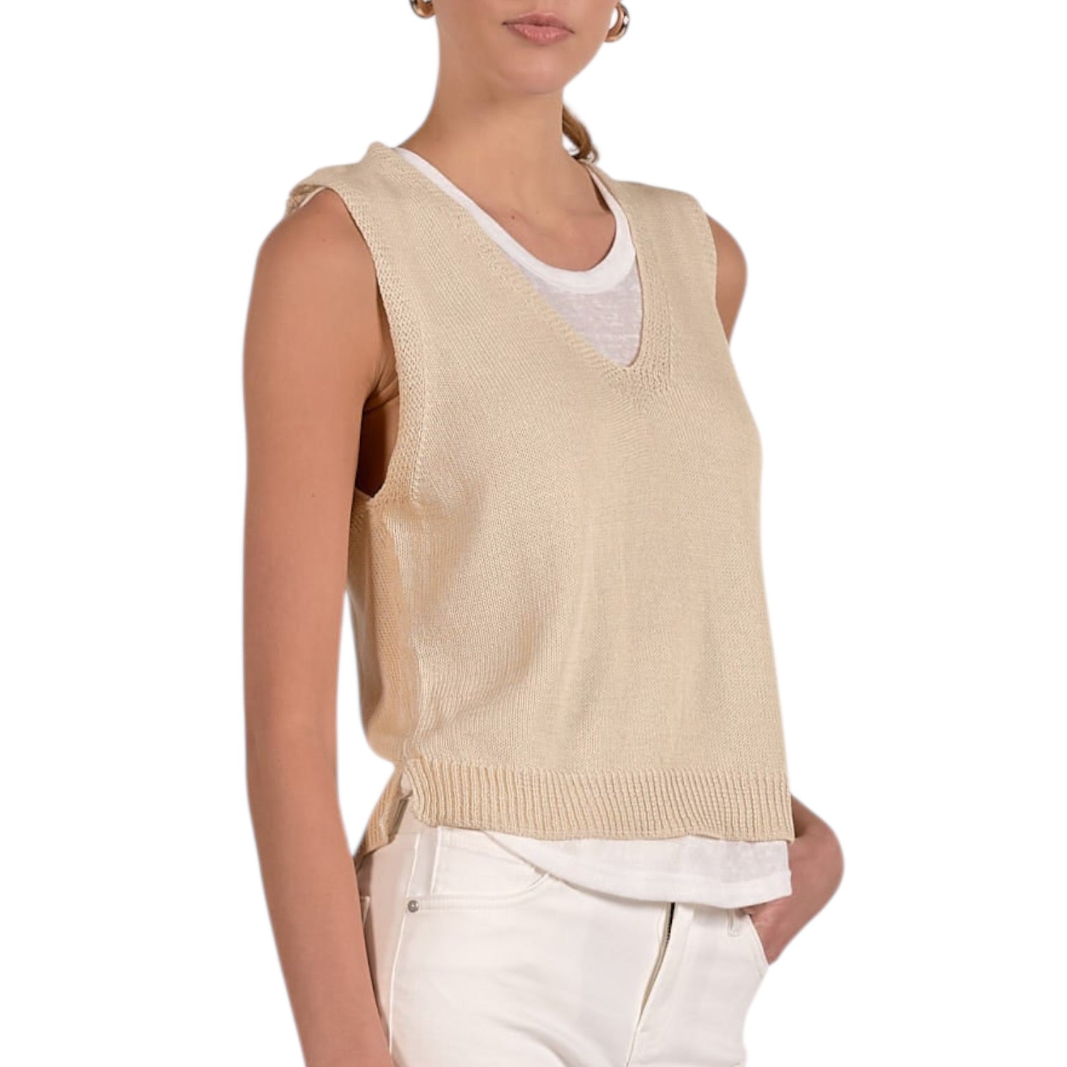 Beige sleeveless sweater over a white shirt on a white background