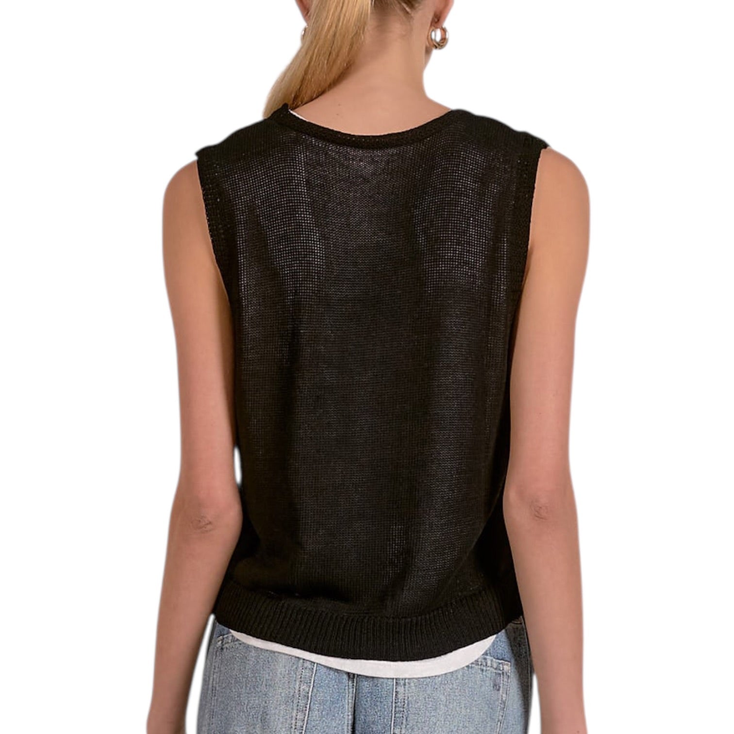 Person wearing a black sleeveless top with a white background