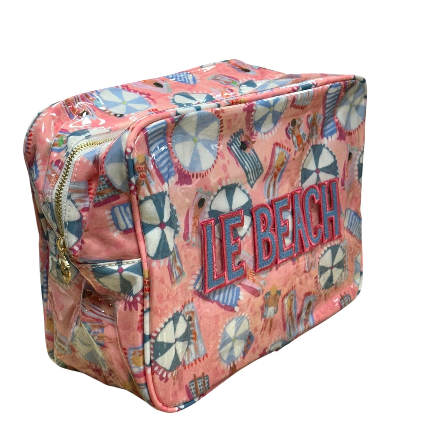 Pink beach bag with 'LE BEACH' text and umbrella pattern on a white background