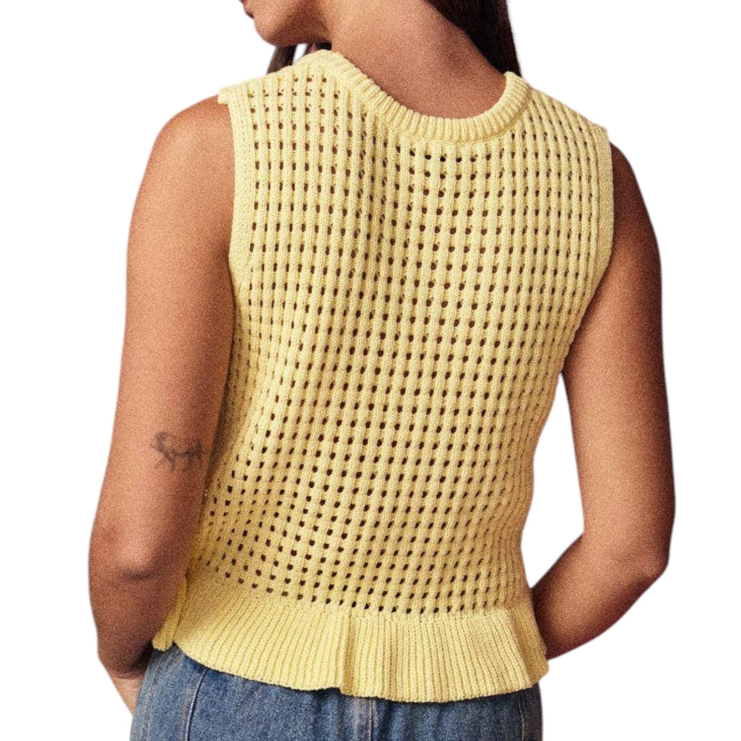Yellow sleeveless knitted top worn by a person on a white background
