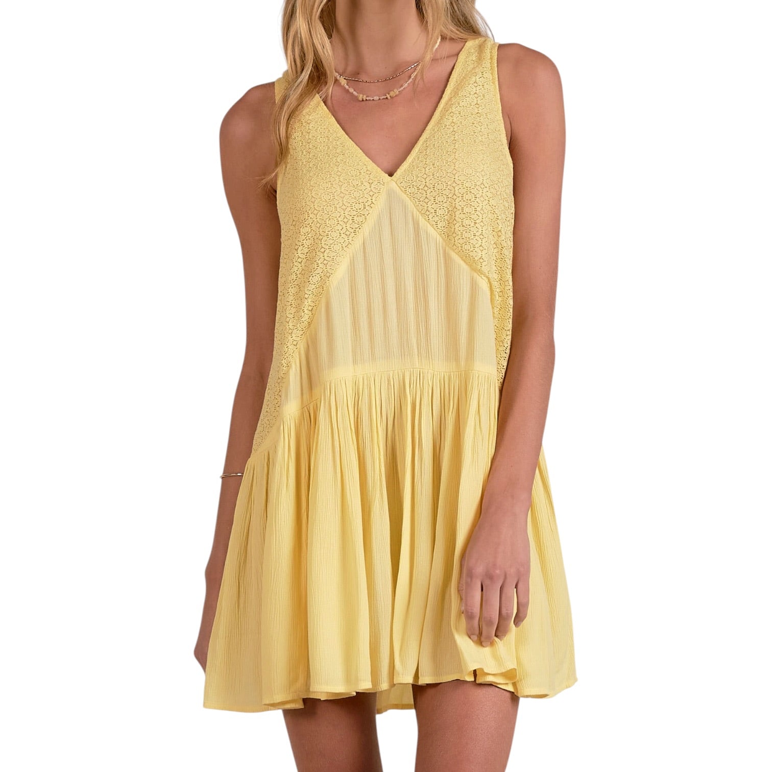 Yellow dress worn by a model on a white background