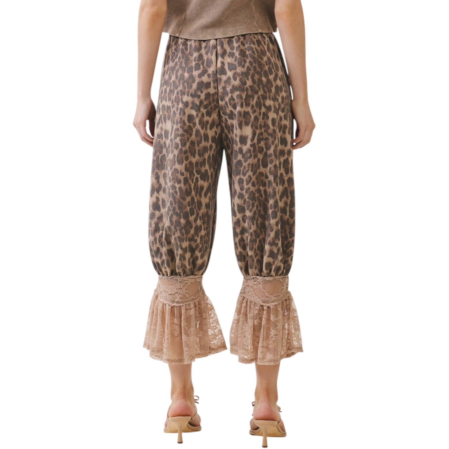 Leopard print pants with ruffled bottom hem on a white background