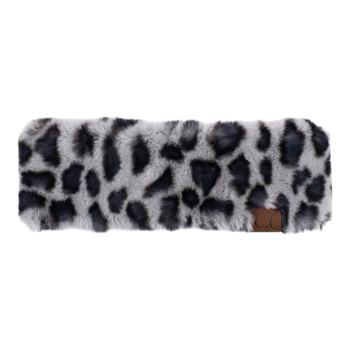 A faux fur headband with a gray, black, and white leopard print pattern, featuring a small brown leather brand patch on the right side.