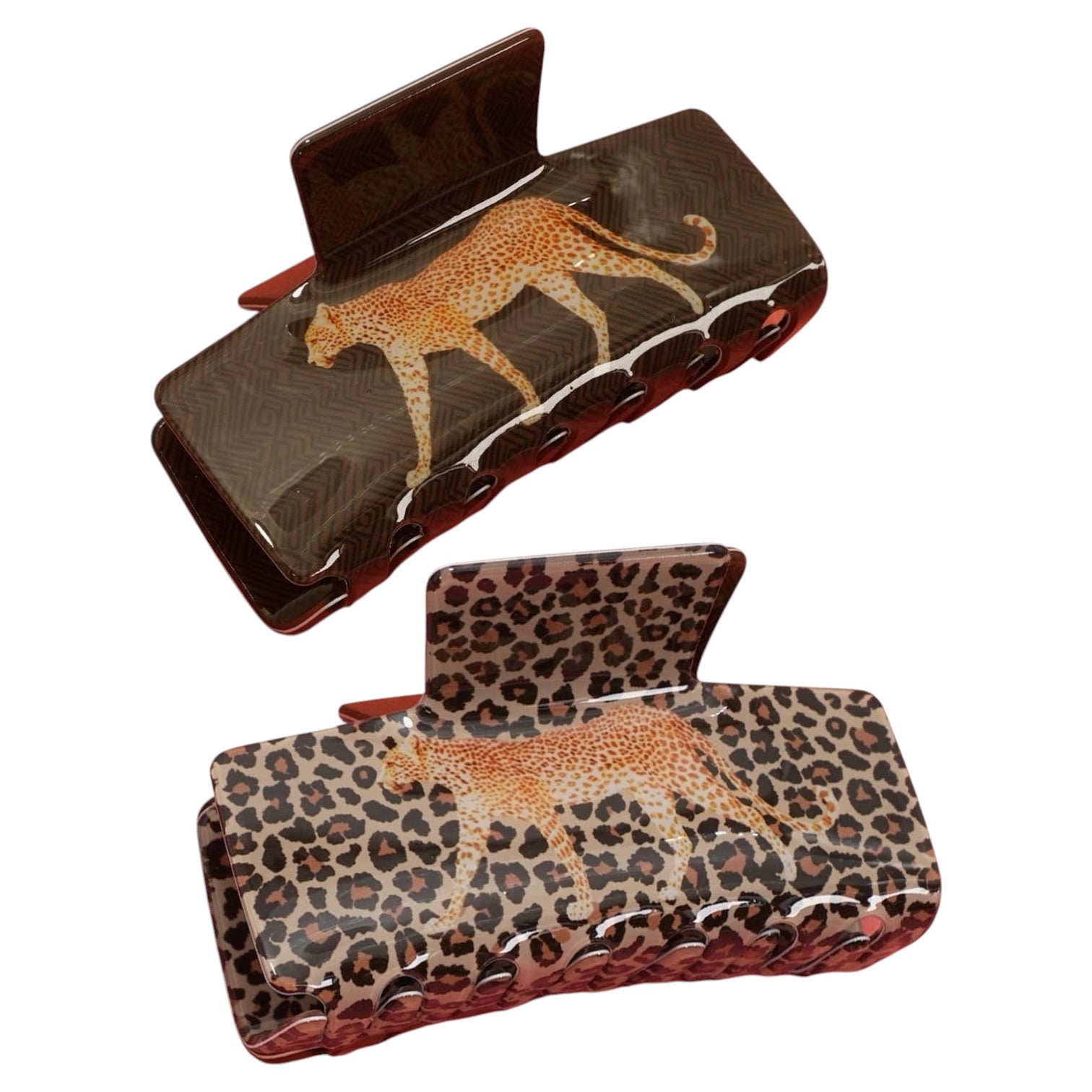 Two hair claw clips shown on a plain white background, one with a dark brown cheetah print and the other with a leopard print, both featuring textured sides and reddish-brown inner clasp areas.