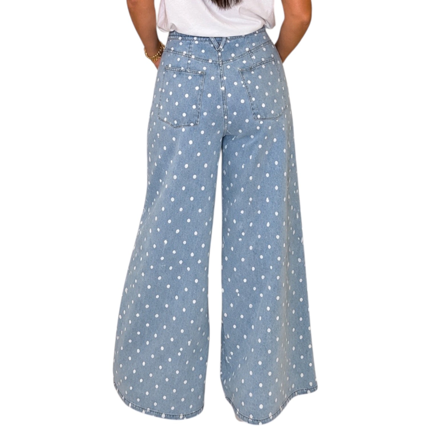 woman wearing light denim polka dot wide leg pants on white background