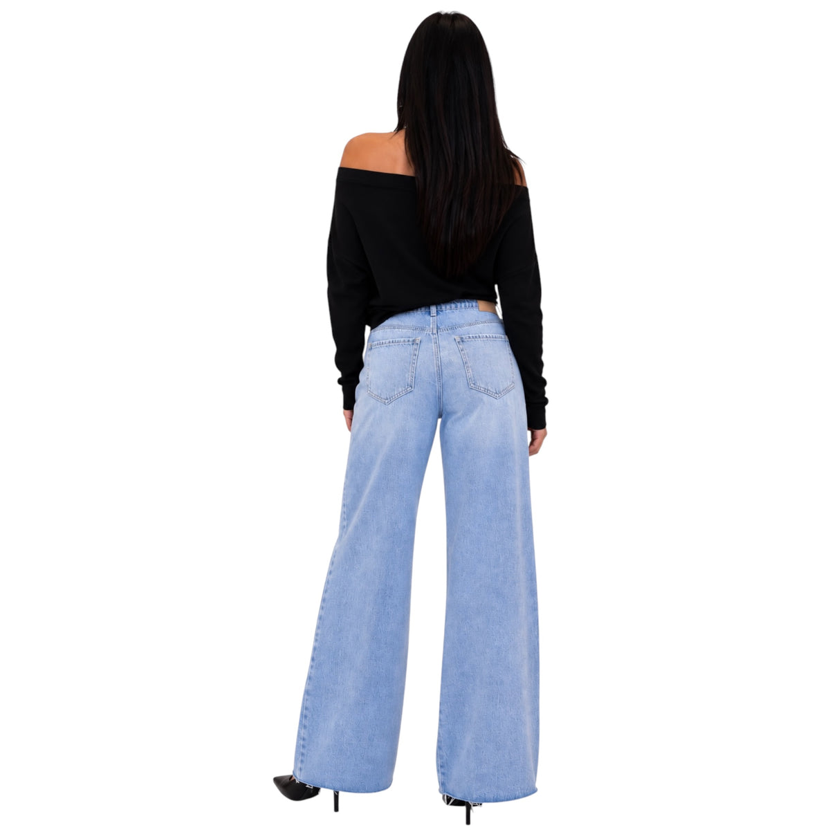 A woman shown from the back wearing light-wash wide-leg denim jeans and a black off-the-shoulder long-sleeve top, standing against a plain white background.