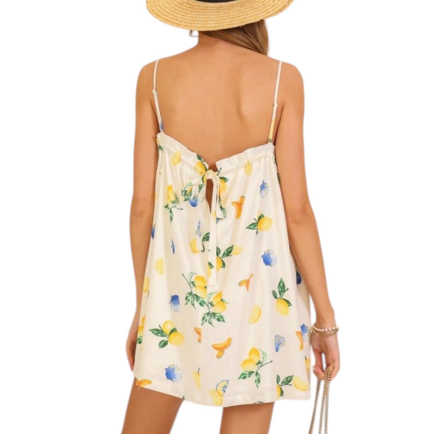 Woman wearing a floral dress with lemon pattern on a white background