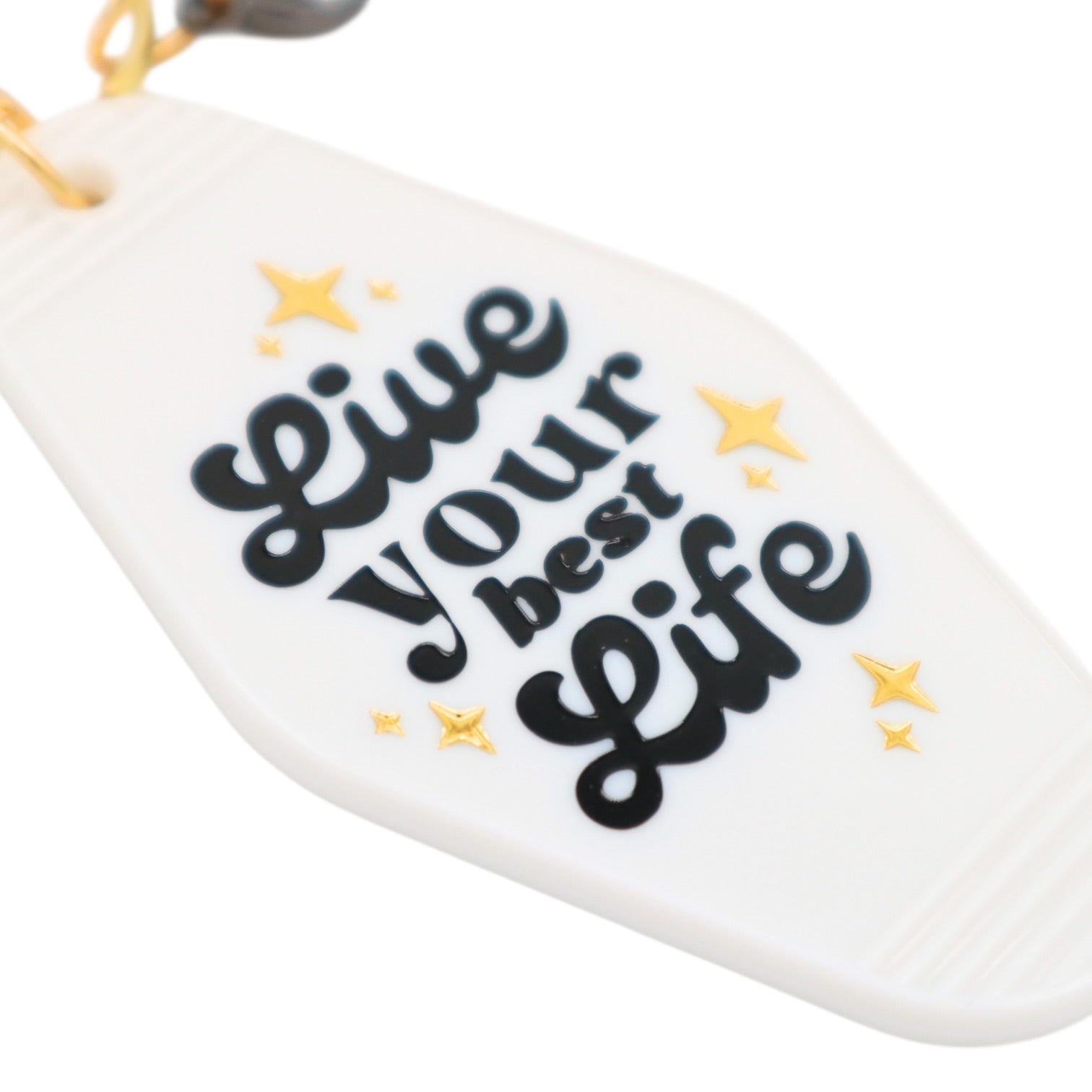 White keychain with 'Live your best life' text and yellow stars on a white background