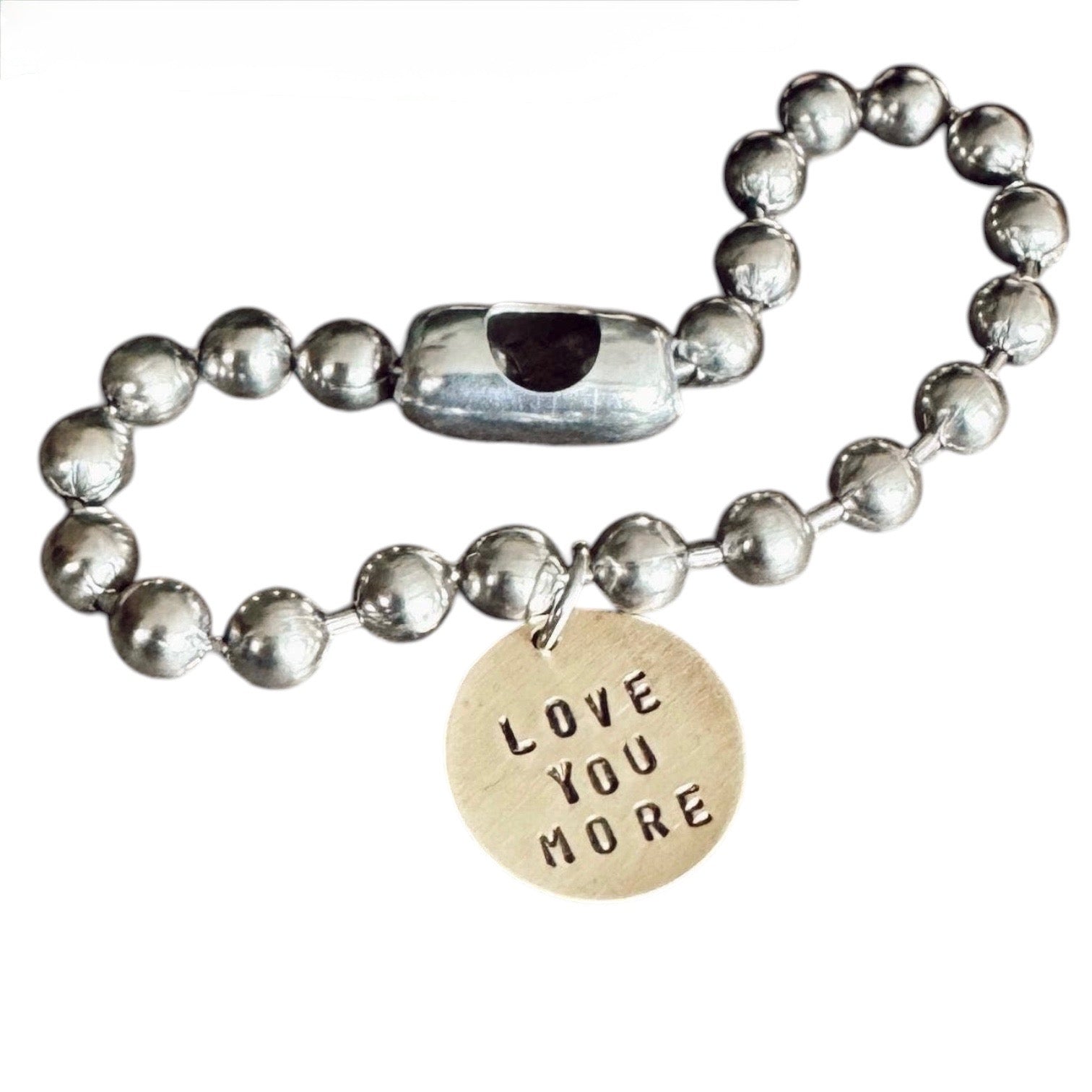Silver beaded bracelet with a 'LOVE YOU MORE' charm on a white background