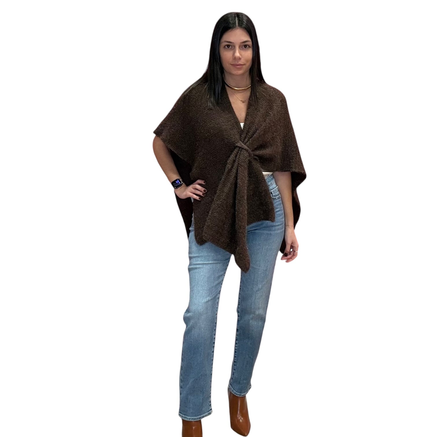 Woman wearing a brown poncho and blue jeans