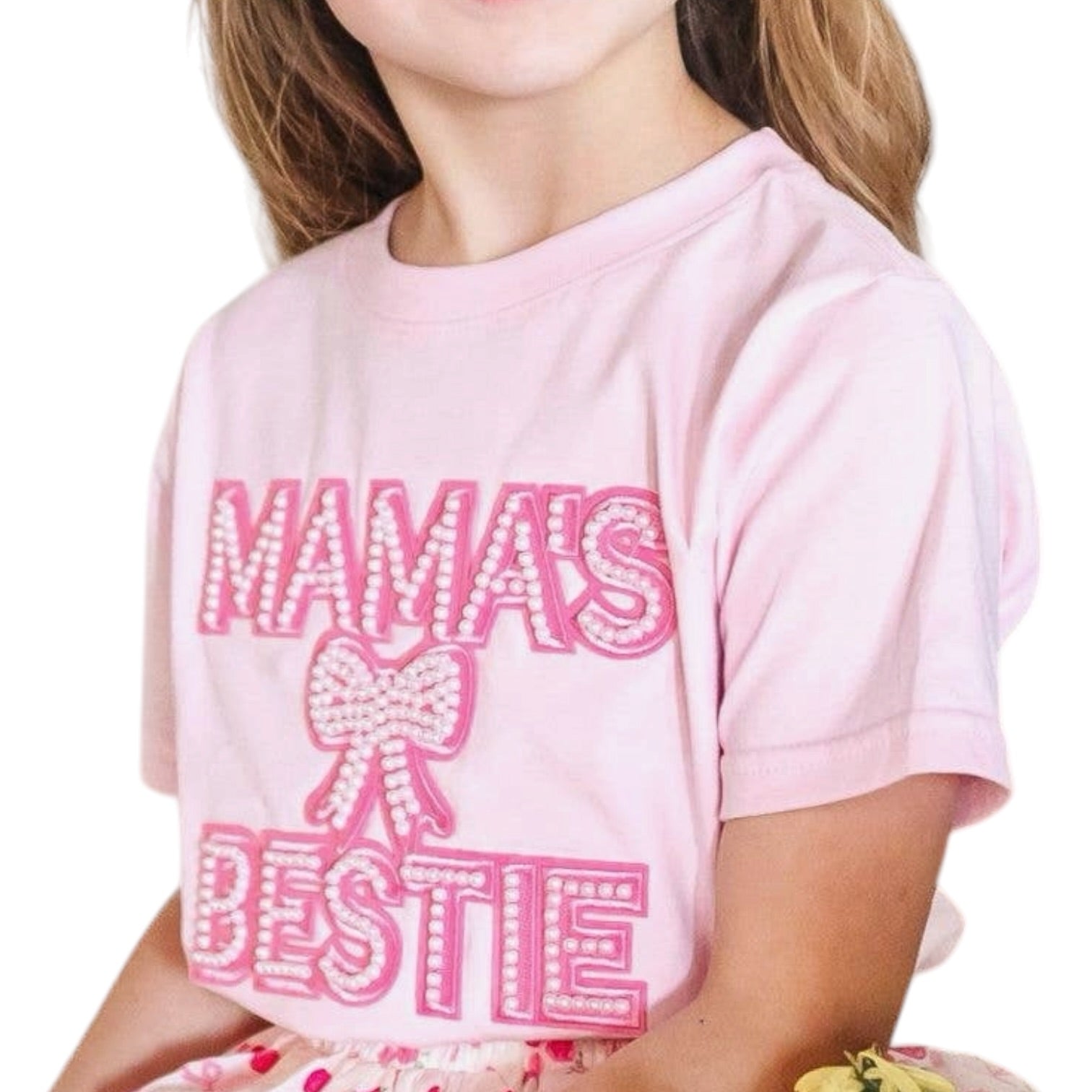 Child wearing a pink t-shirt with 'Mama's Bestie' text and bow graphic.