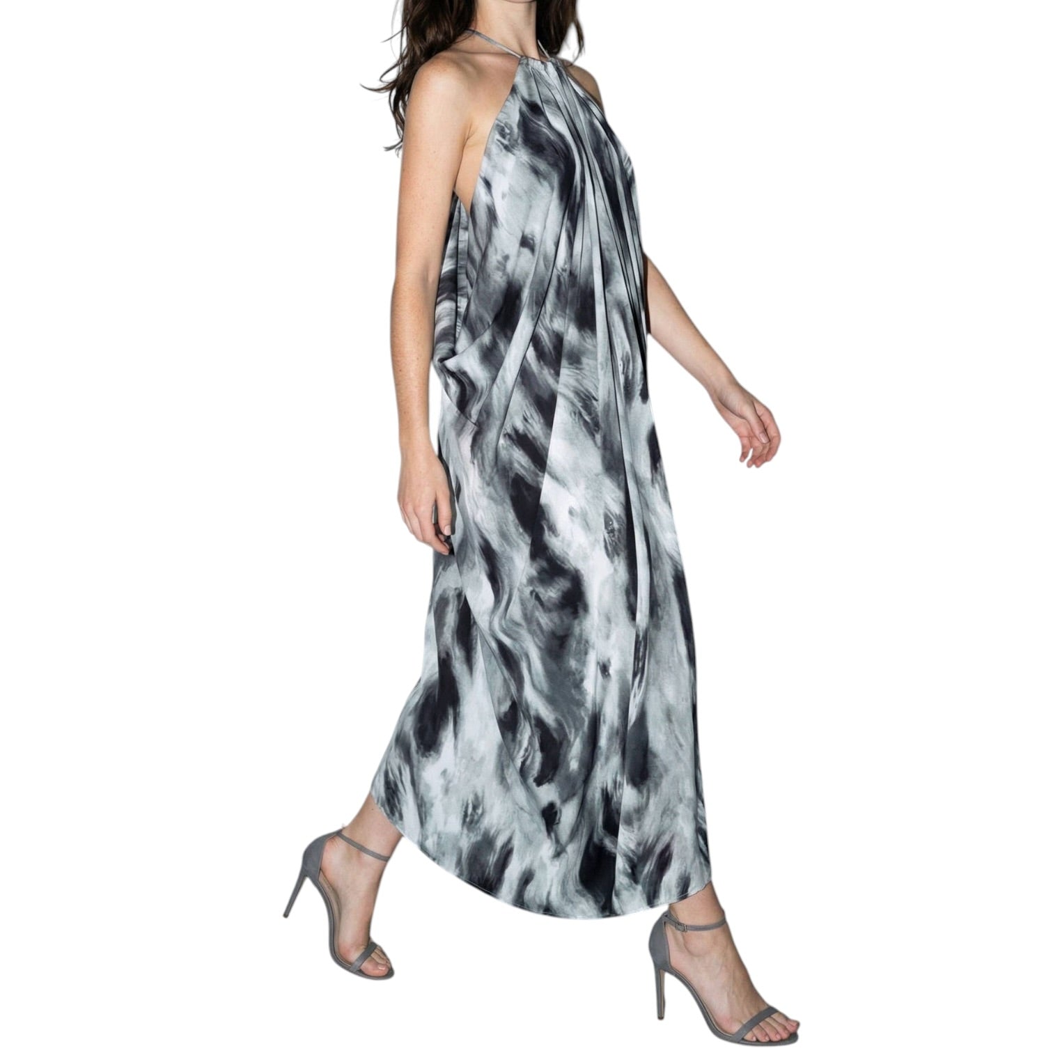 Woman wearing a black and white patterned dress on a white background