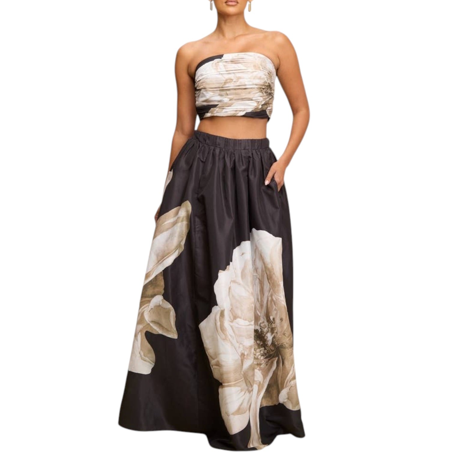 Woman wearing a strapless top and floral skirt on a white background