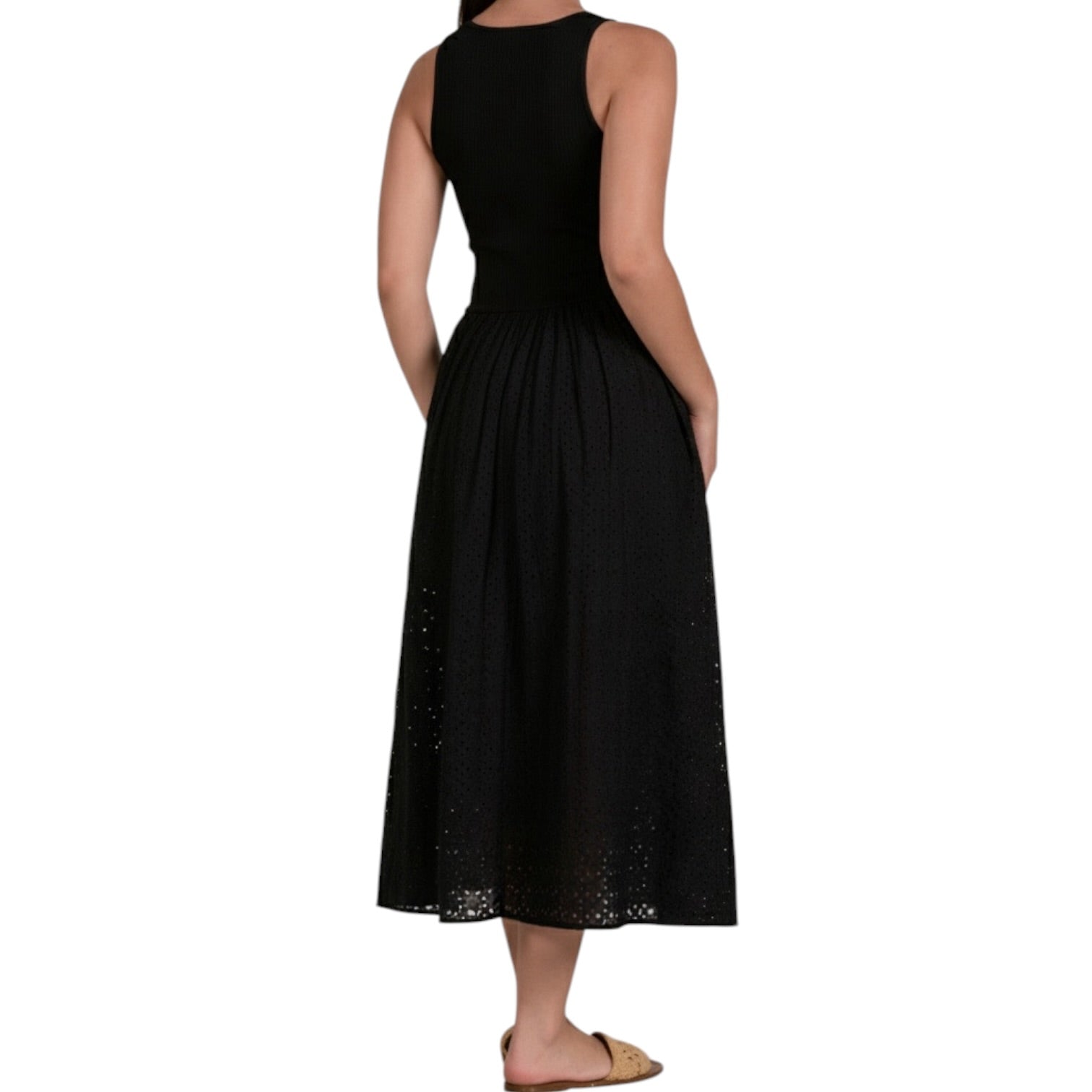 Black sleeveless dress worn by a person on a white background