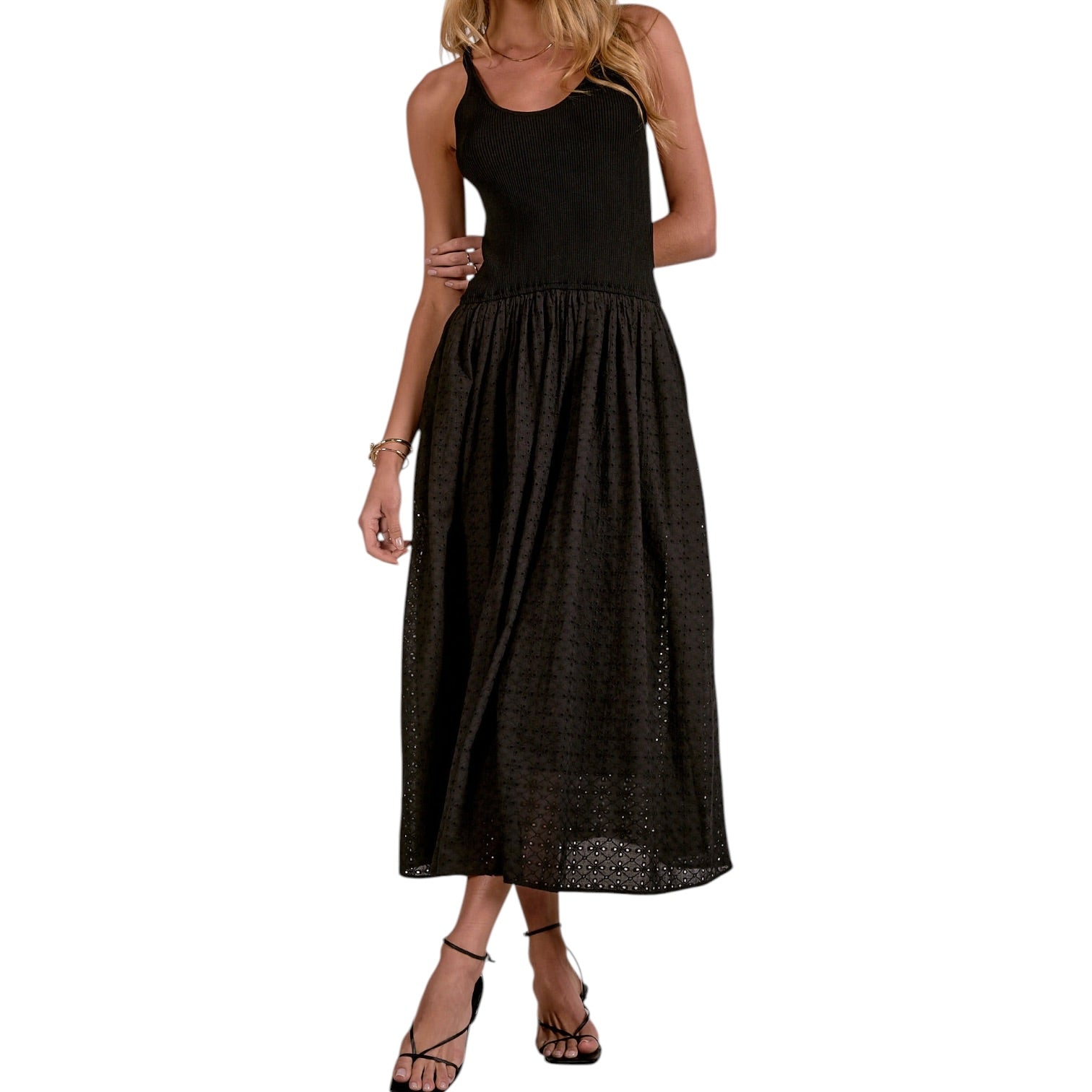 Black sleeveless dress worn by a person on a white background