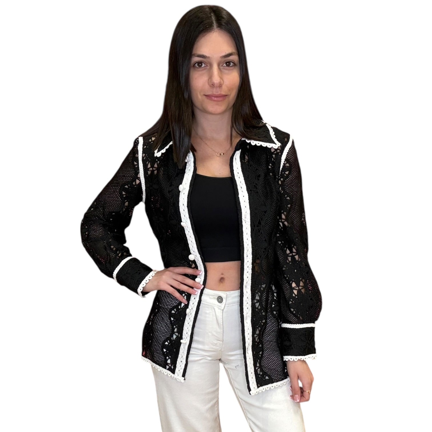 Woman wearing a black and white lace jacket on a white background