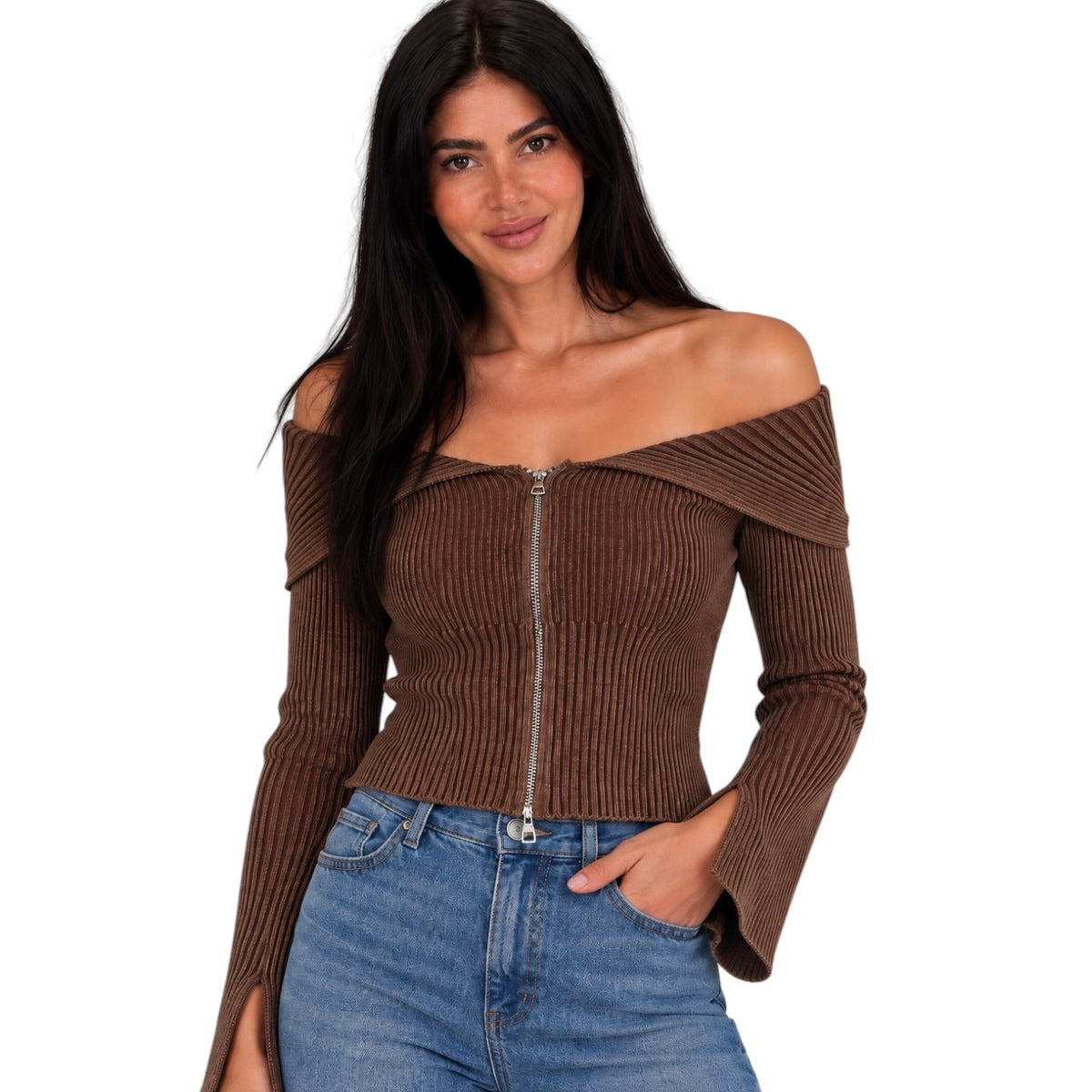 A woman modeling a brown ribbed off-the-shoulder long-sleeve top with a front zipper, paired with blue jeans, against a plain white background.