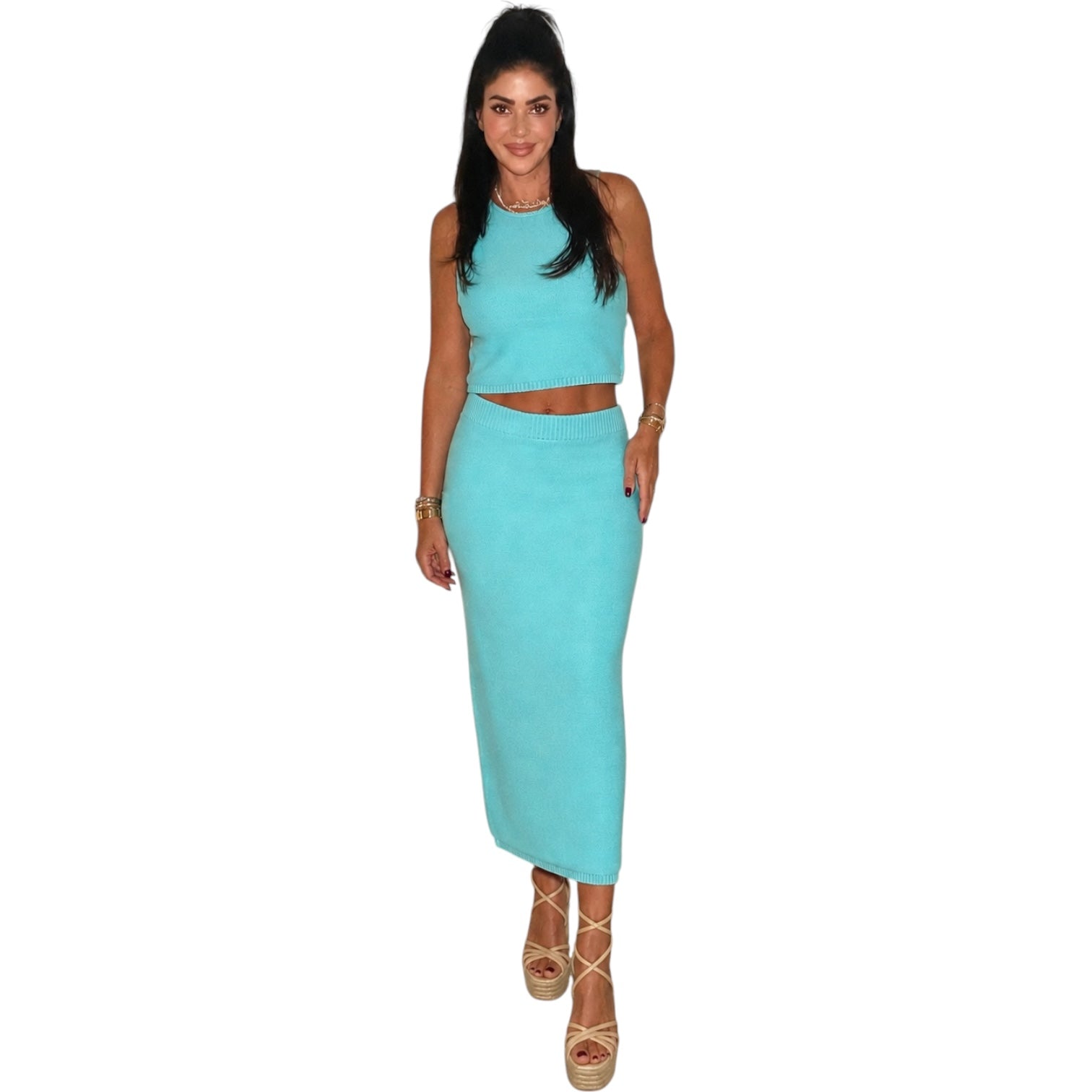 Woman wearing a matching turquoise top and skirt set on a white background