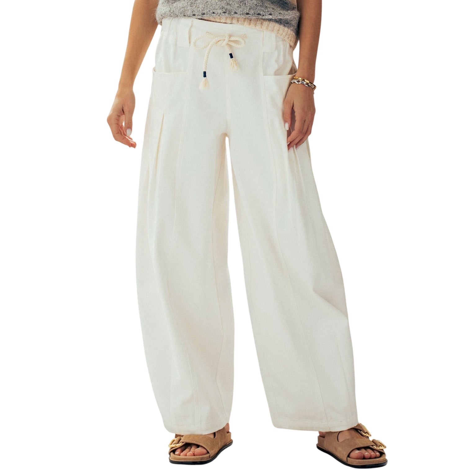 Person wearing white wide-leg pants on a white background