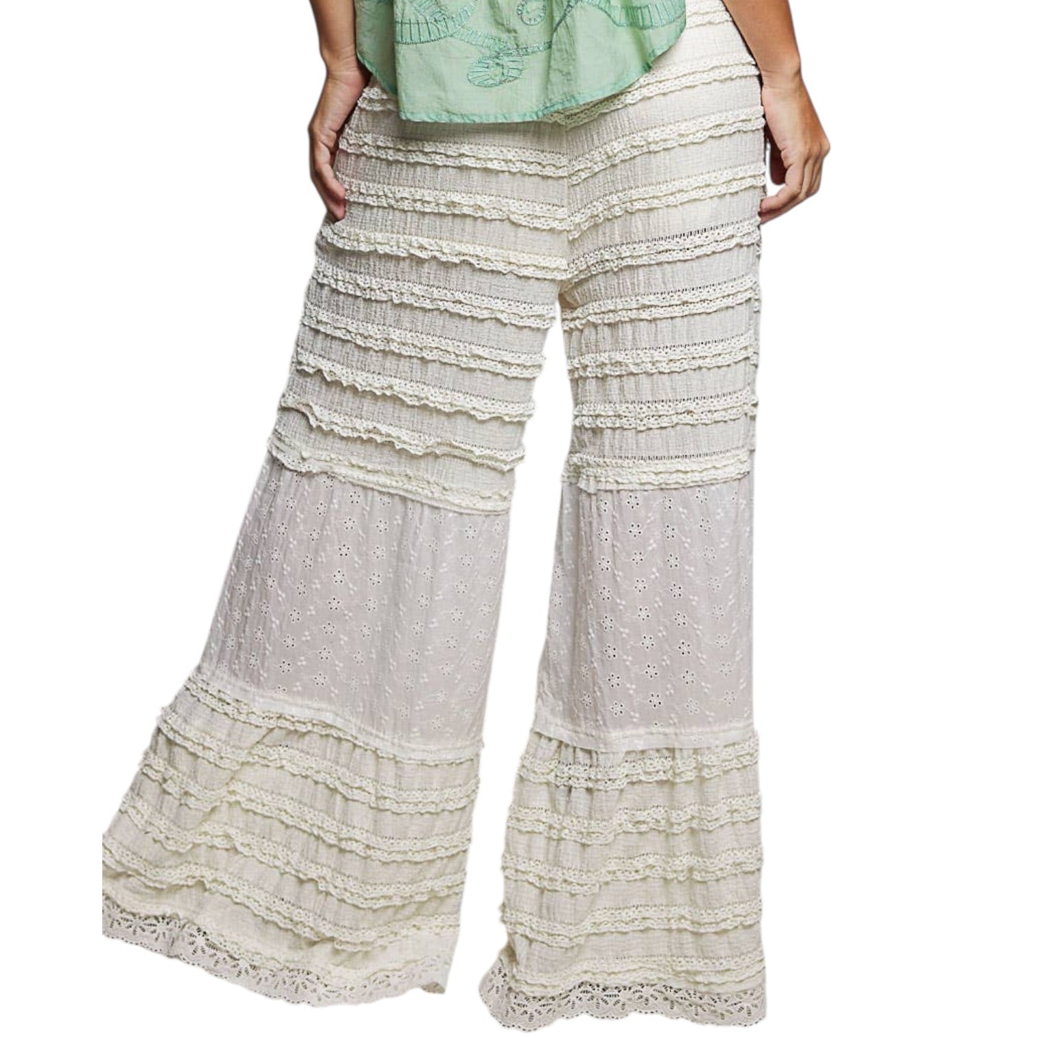 White lace-trimmed pants on a white background