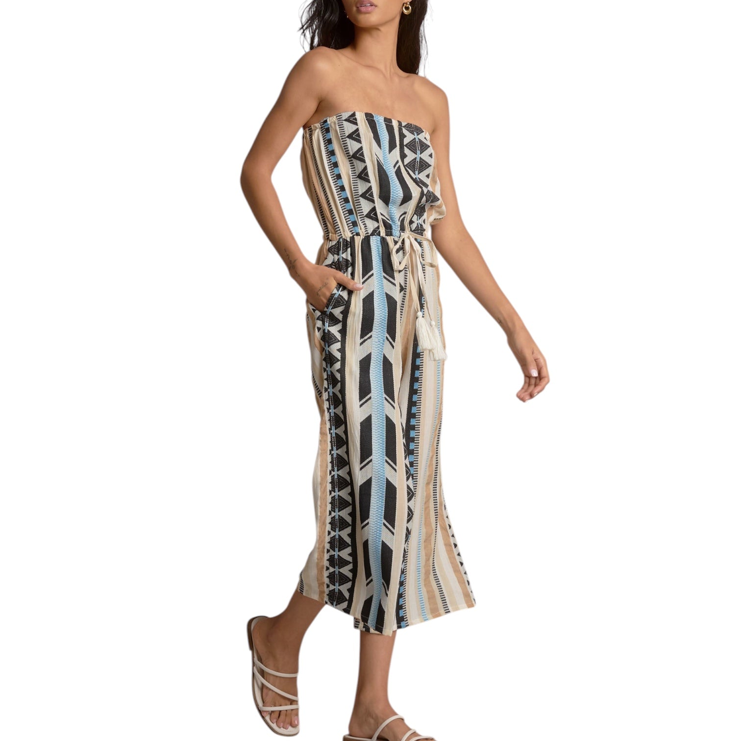 Woman wearing a strapless, patterned dress on a white background