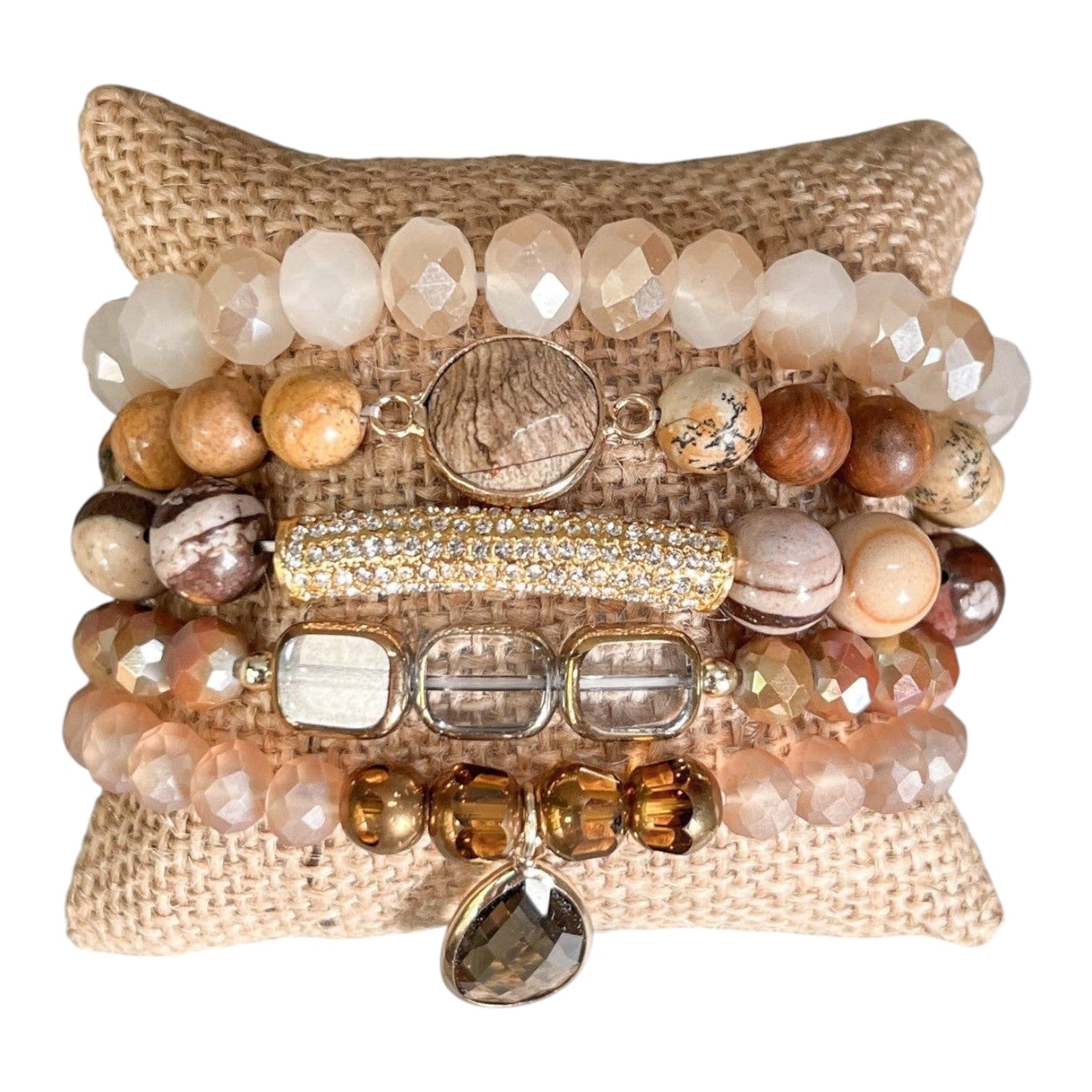 Stack of beaded bracelets on a textured surface