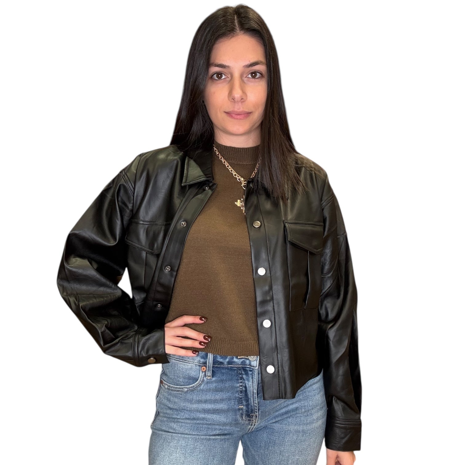 Woman wearing a black leather jacket over a olive sweater with a white background