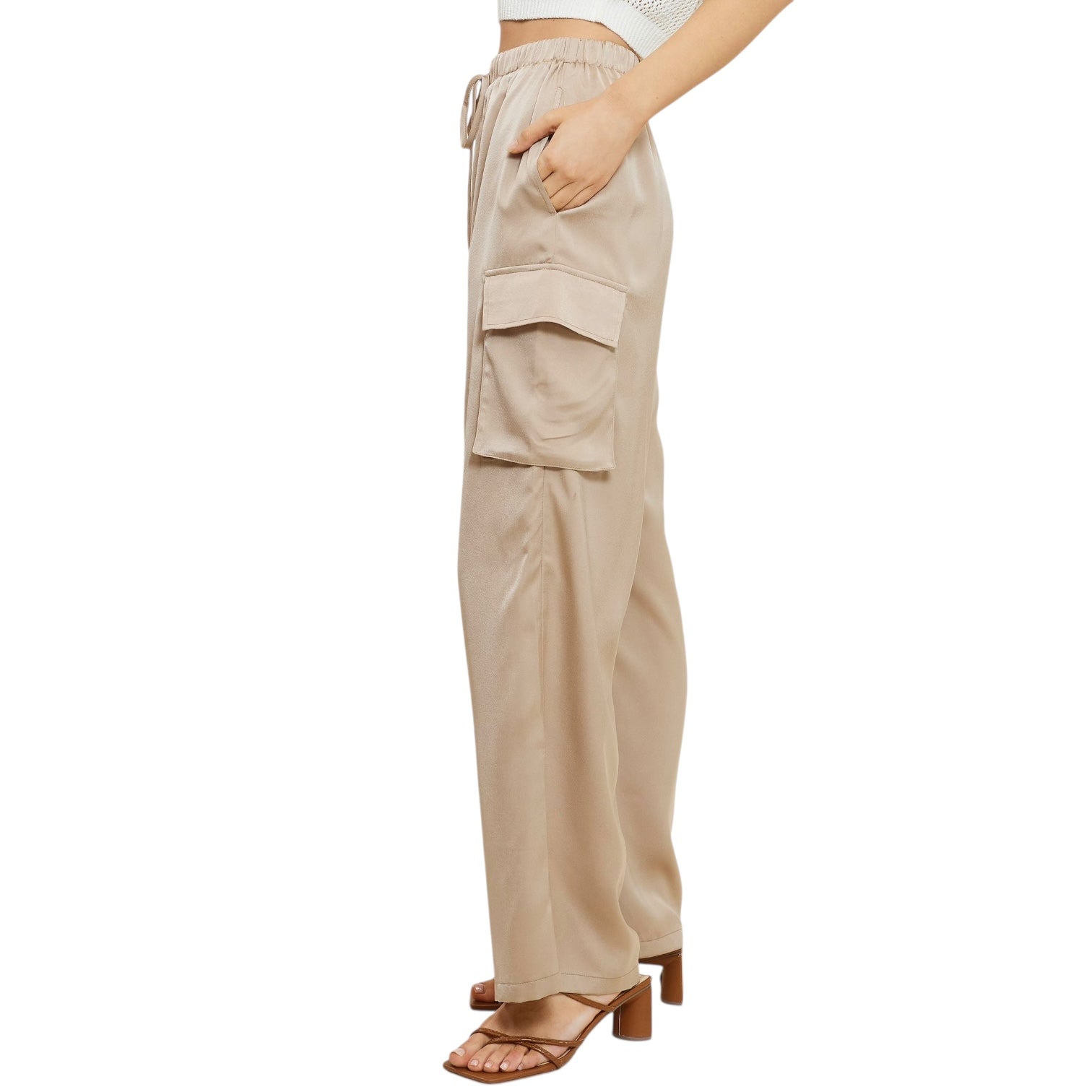 Nude cargo pants worn by a person on a white background