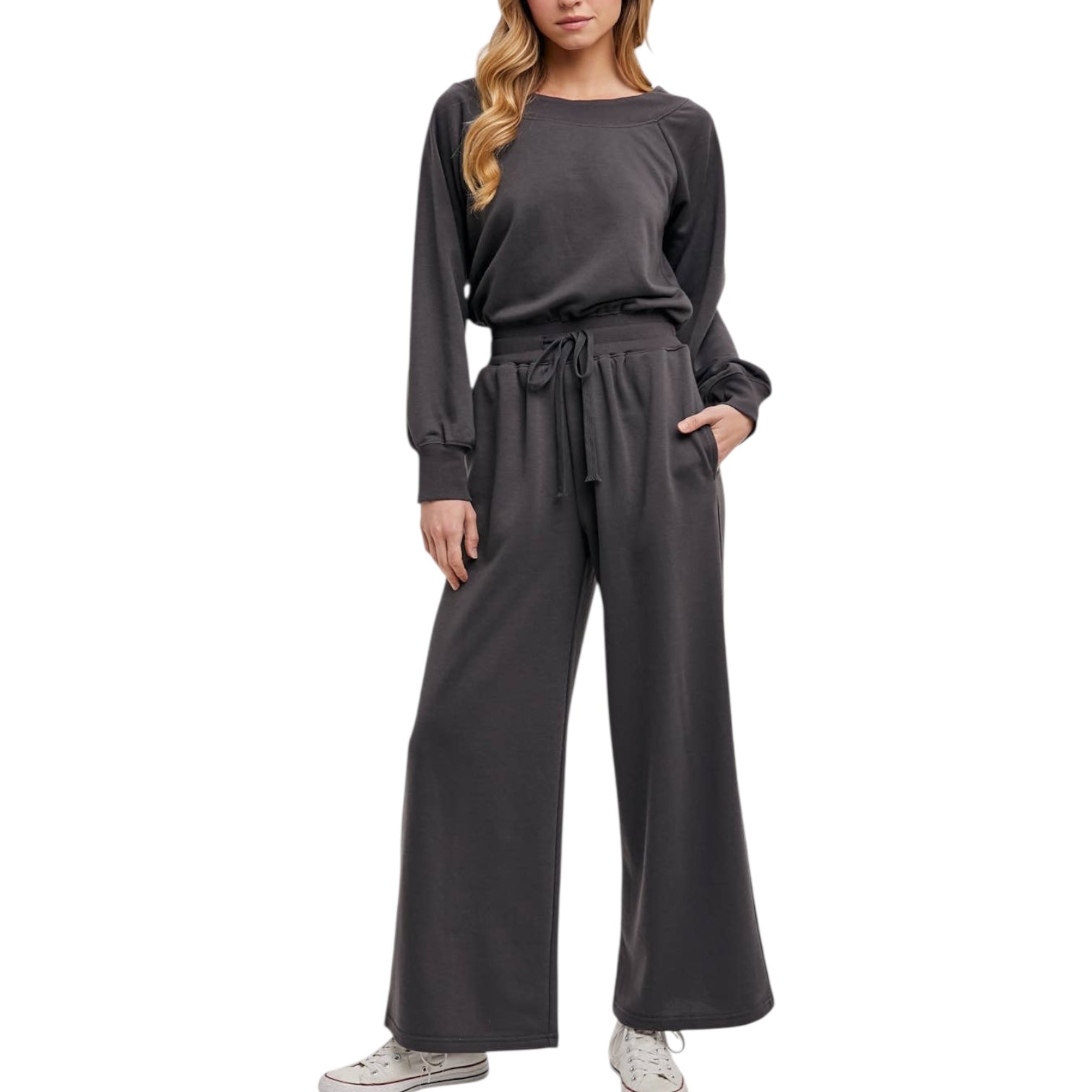 Woman wearing a gray jumpsuit on a white background