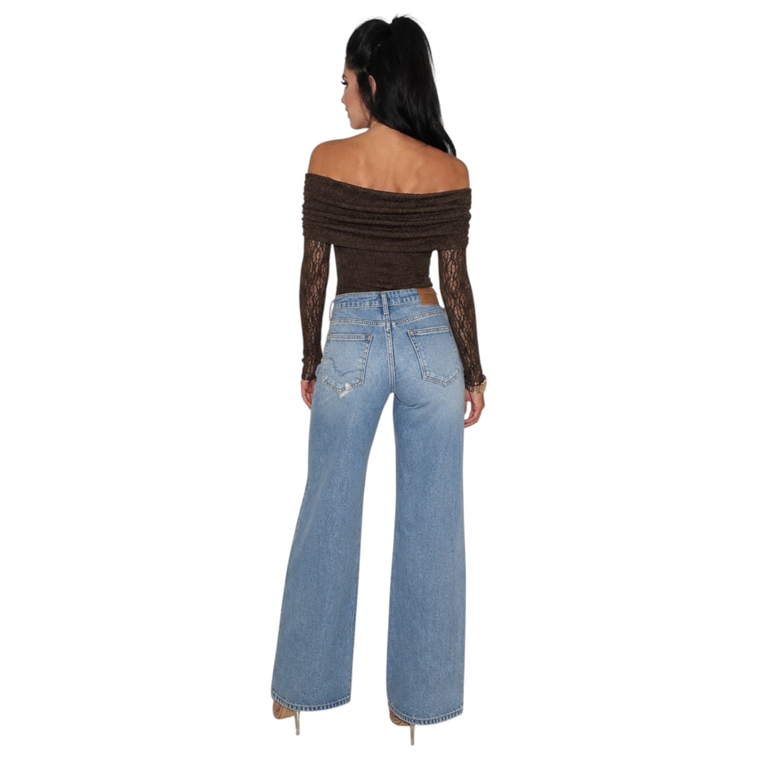 A woman shown from the back wearing a dark brown off-the-shoulder long-sleeve bodysuit with sheer lace sleeves and light-wash blue wide-leg jeans, against a plain white background.