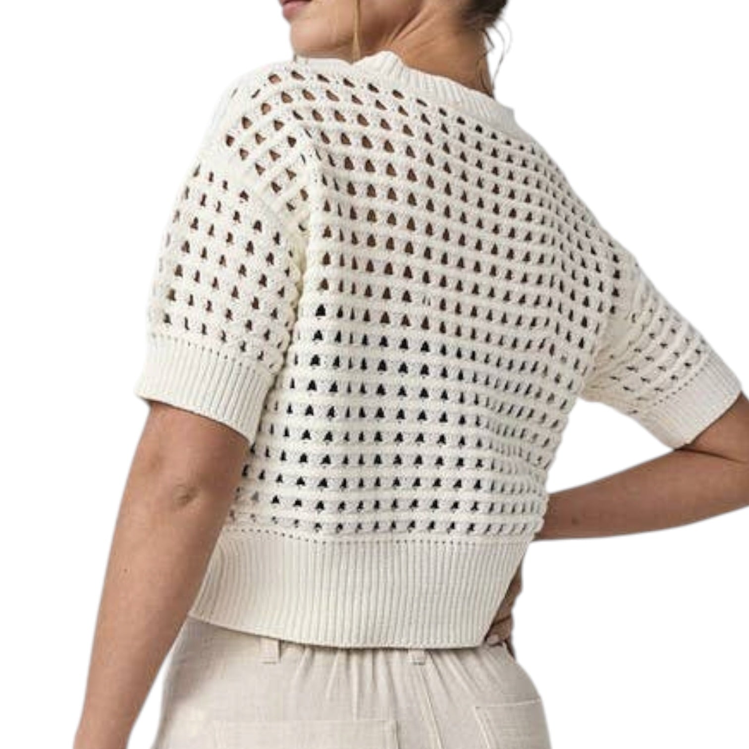 White crochet top worn by a person on a white background