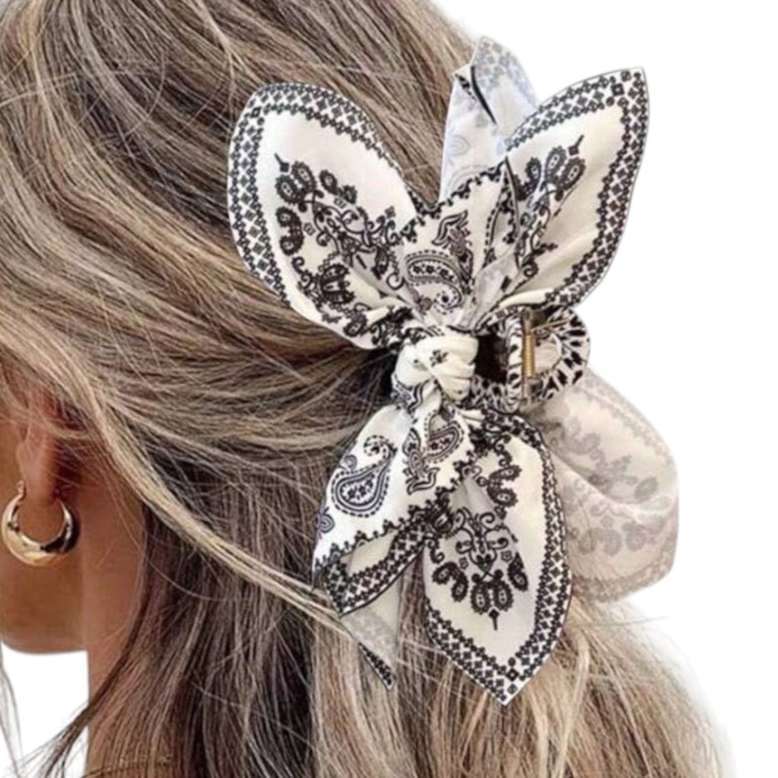 Hair scrunchie with black paisley pattern on a white background
