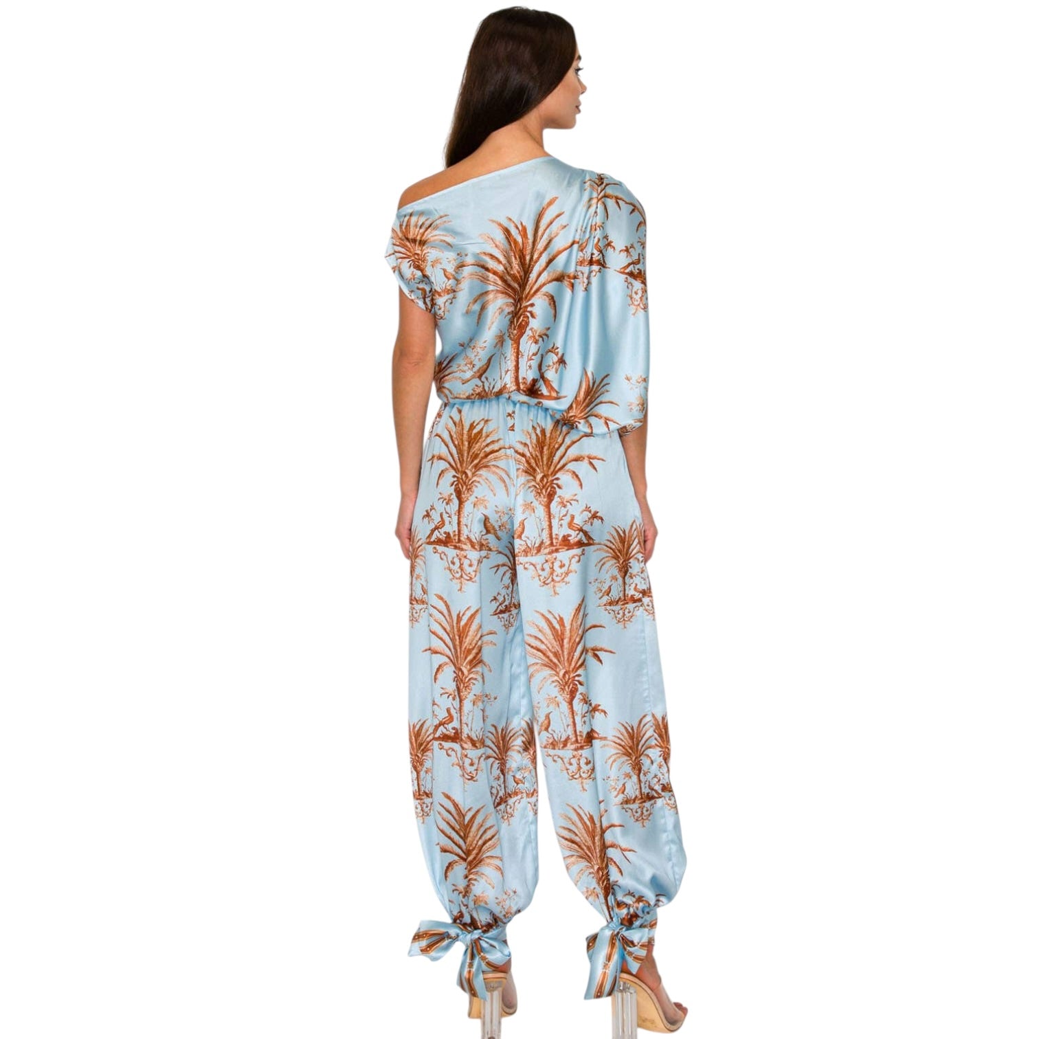 Woman wearing a floral jumpsuit on a white background