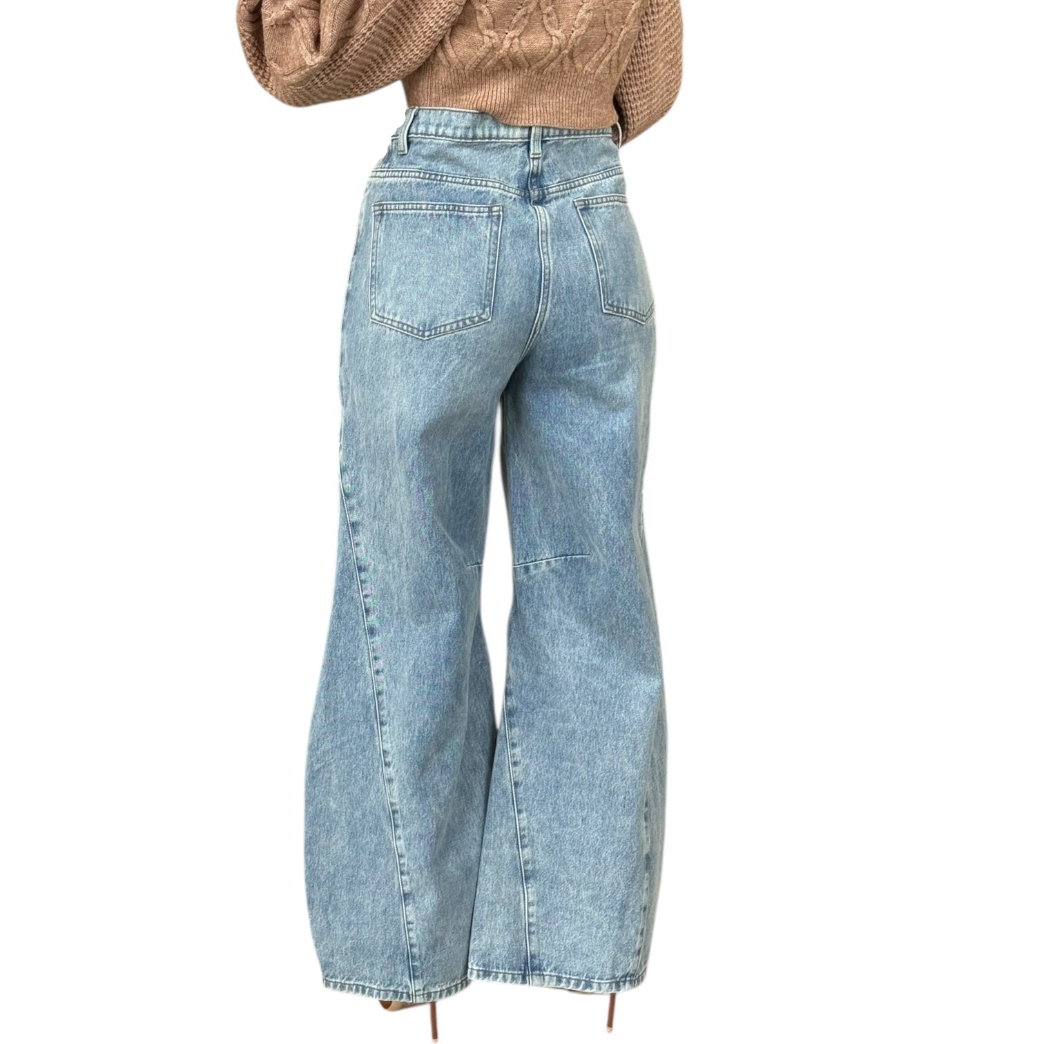 Light blue jeans worn by a person on a white background