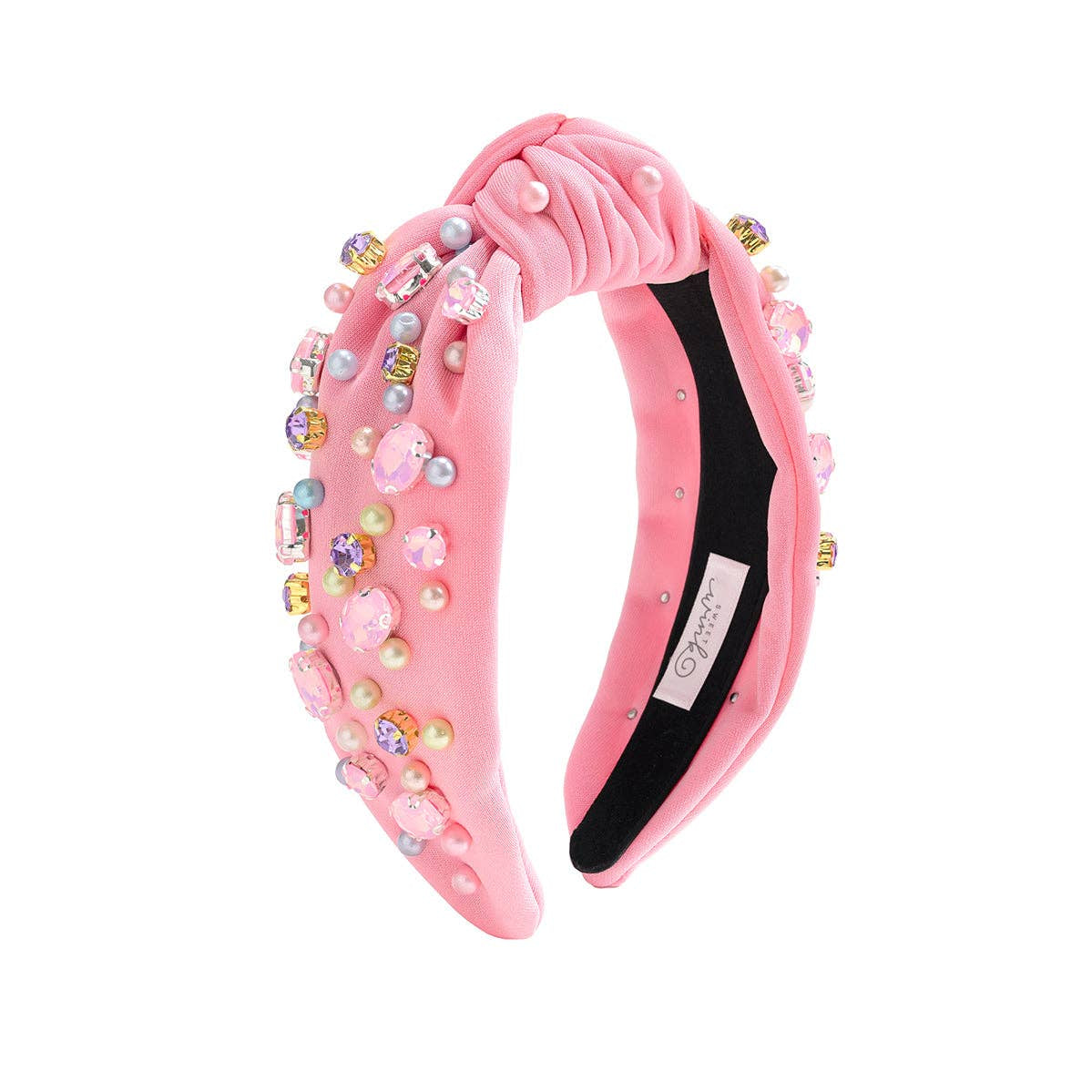 Pink headband with embellishments on a white background