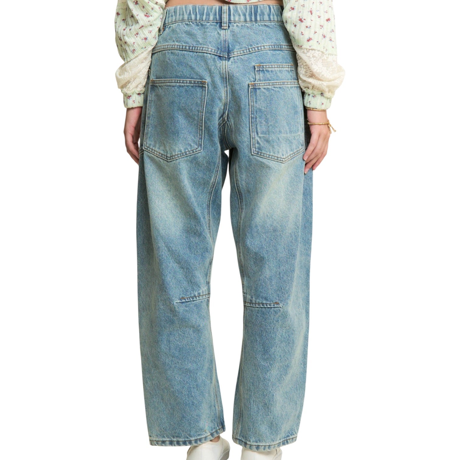Blue jeans worn by a person on a white background