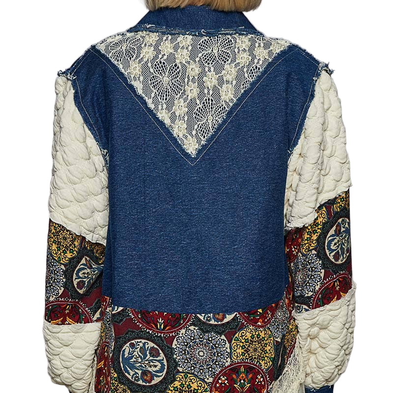 Person wearing a patchwork vest with a floral pattern on a plain background